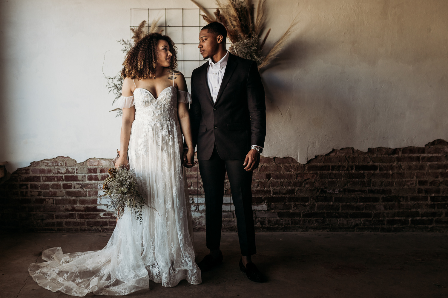 Stylish bride and groom stare into each others eye in old historic building conway ar photographer