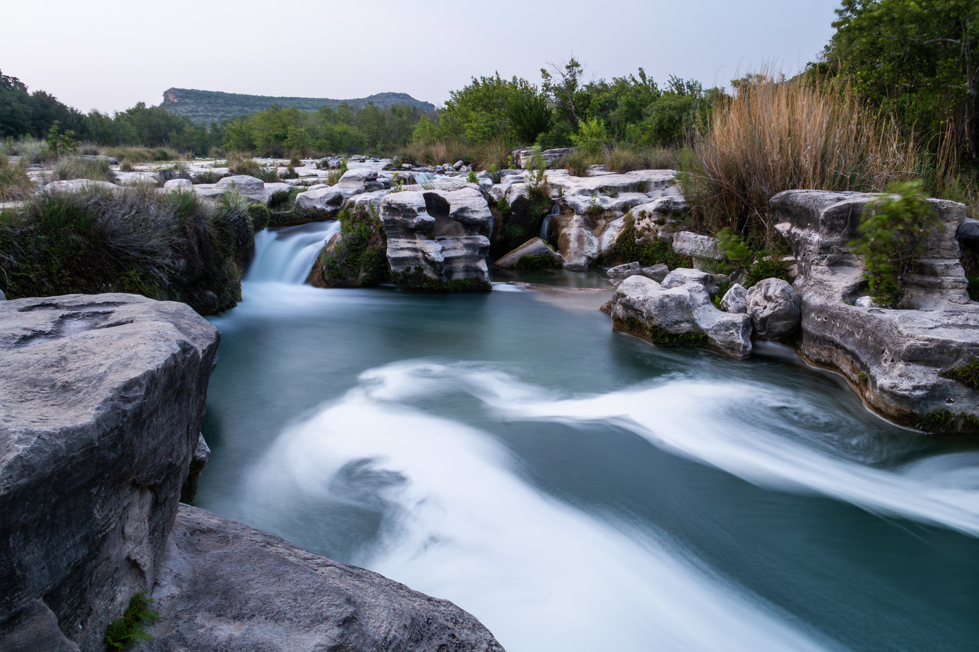 Water rushes in the evening down Dolan Falls in Devils River State Natural Preserve in Val Verde County, Texas.
