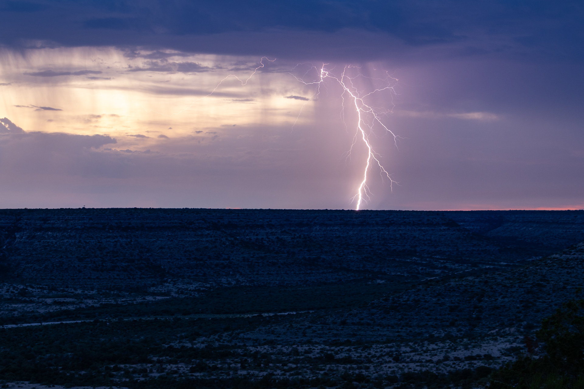 A bolt of lighting flashes in the late evening sky near Independence Creek Preserve in west Texas.
