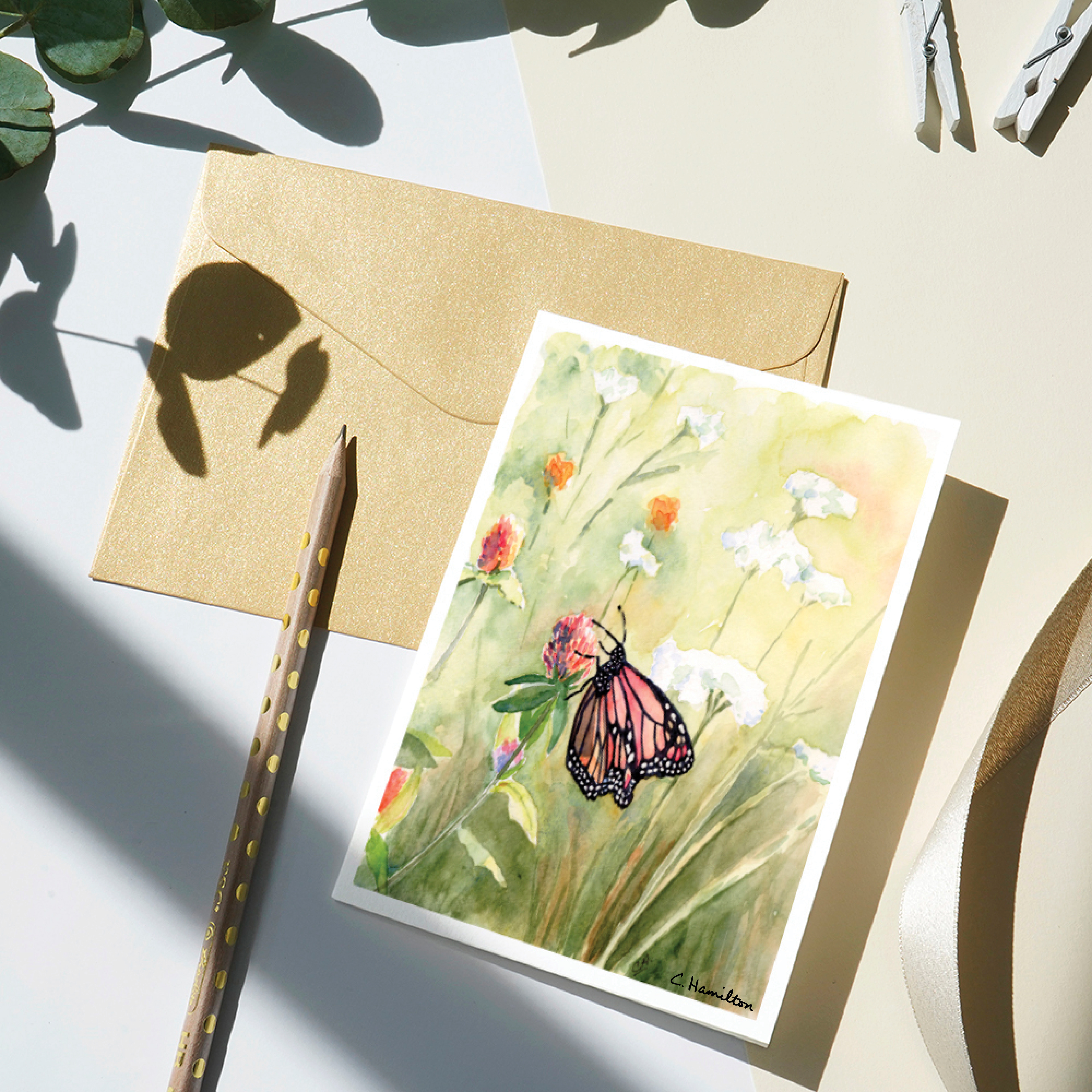 notecard with watercolor butterfly on flower in meadow