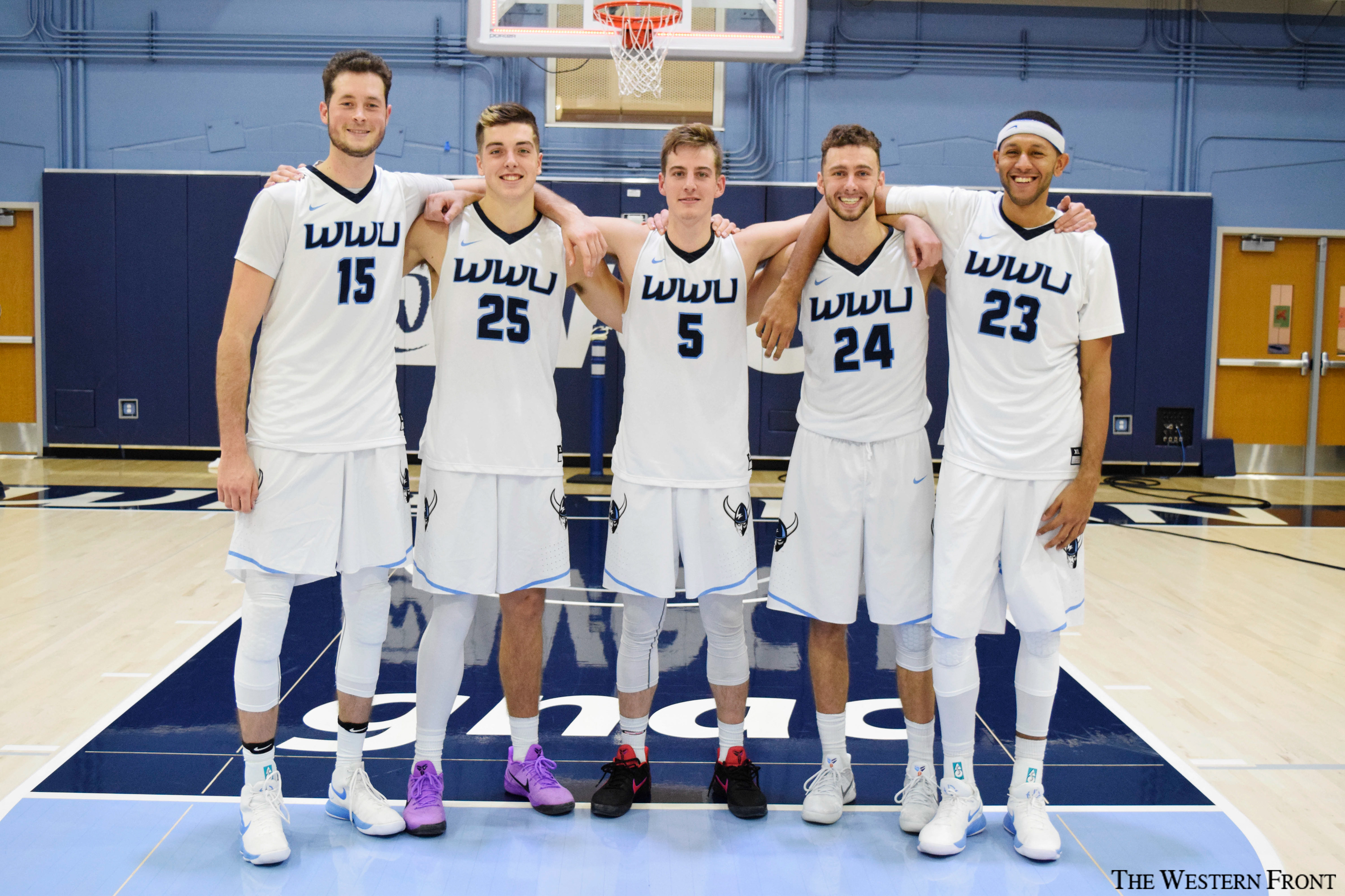 Junior Logan Schilder, sophomore Daulton Hommes, junior Trey Dreschsel, sophomore Trevor Jasinsky and senior Deandre Dickson pose for a group photo in Carver Gym on Nov. 15, 2017. The five starters for Western Washington University men’s basketball are all 6-foot-6 or taller.