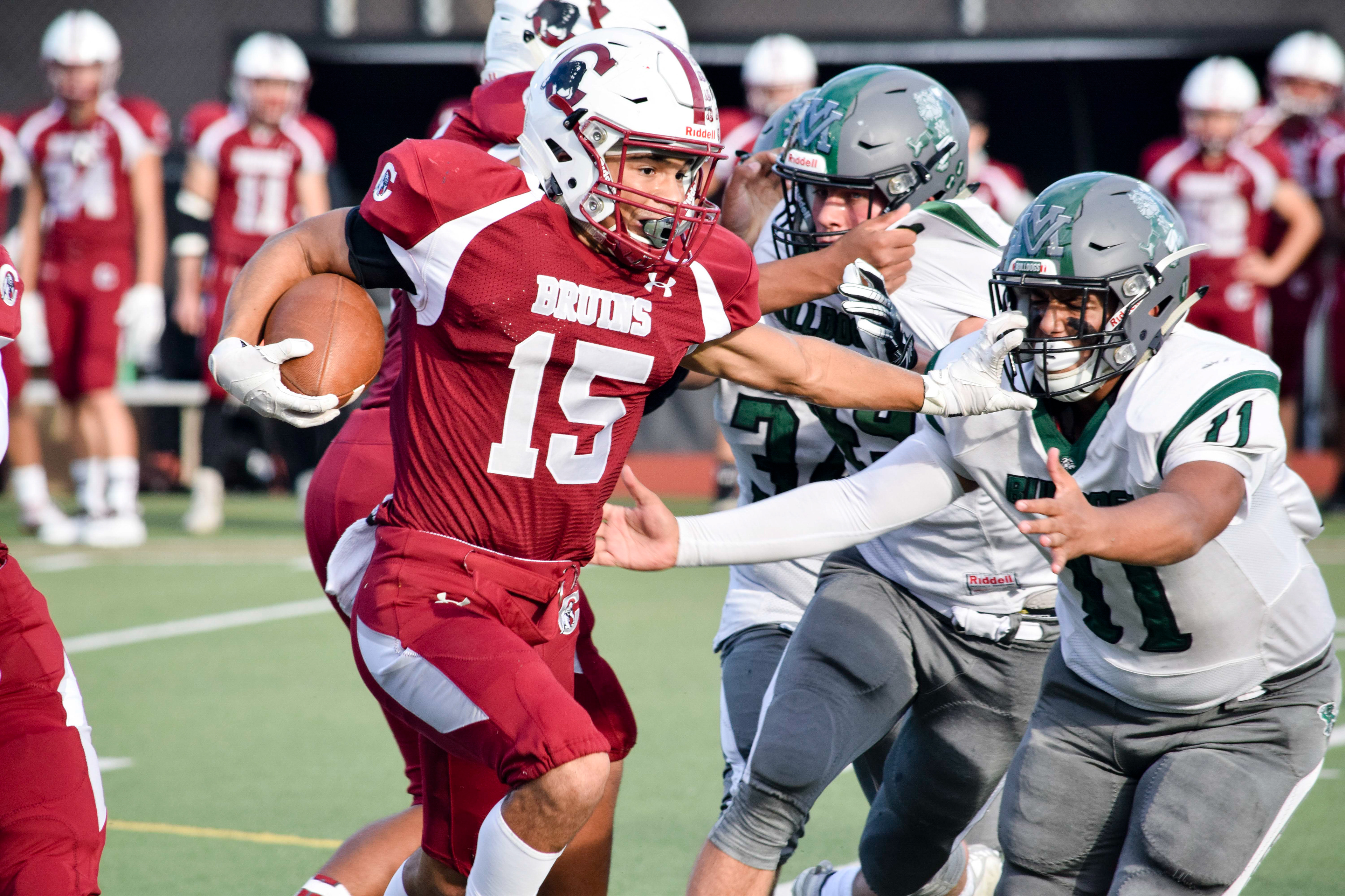 Senior running back Davanta Murphy-Mcmillan stiff-arms a Mount Vernon defender on Friday, Sept. 20 at Everett Memorial Stadium. (Katie Webber / The Herald)