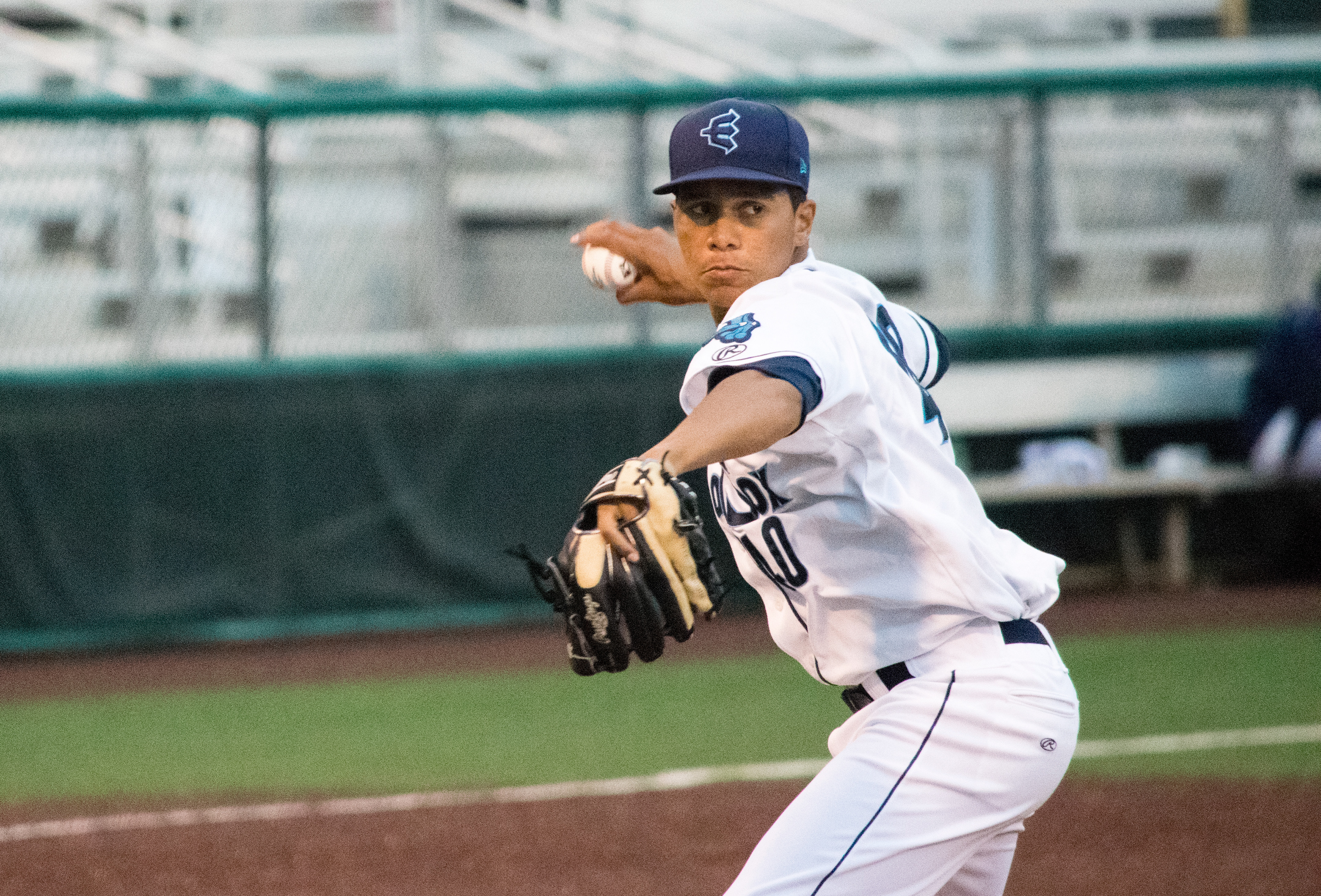 AquaSox pitcher Juan Then throws to first base during a game against the Hawks on July 2 in Everett. (Katie Webber / The Herald)
