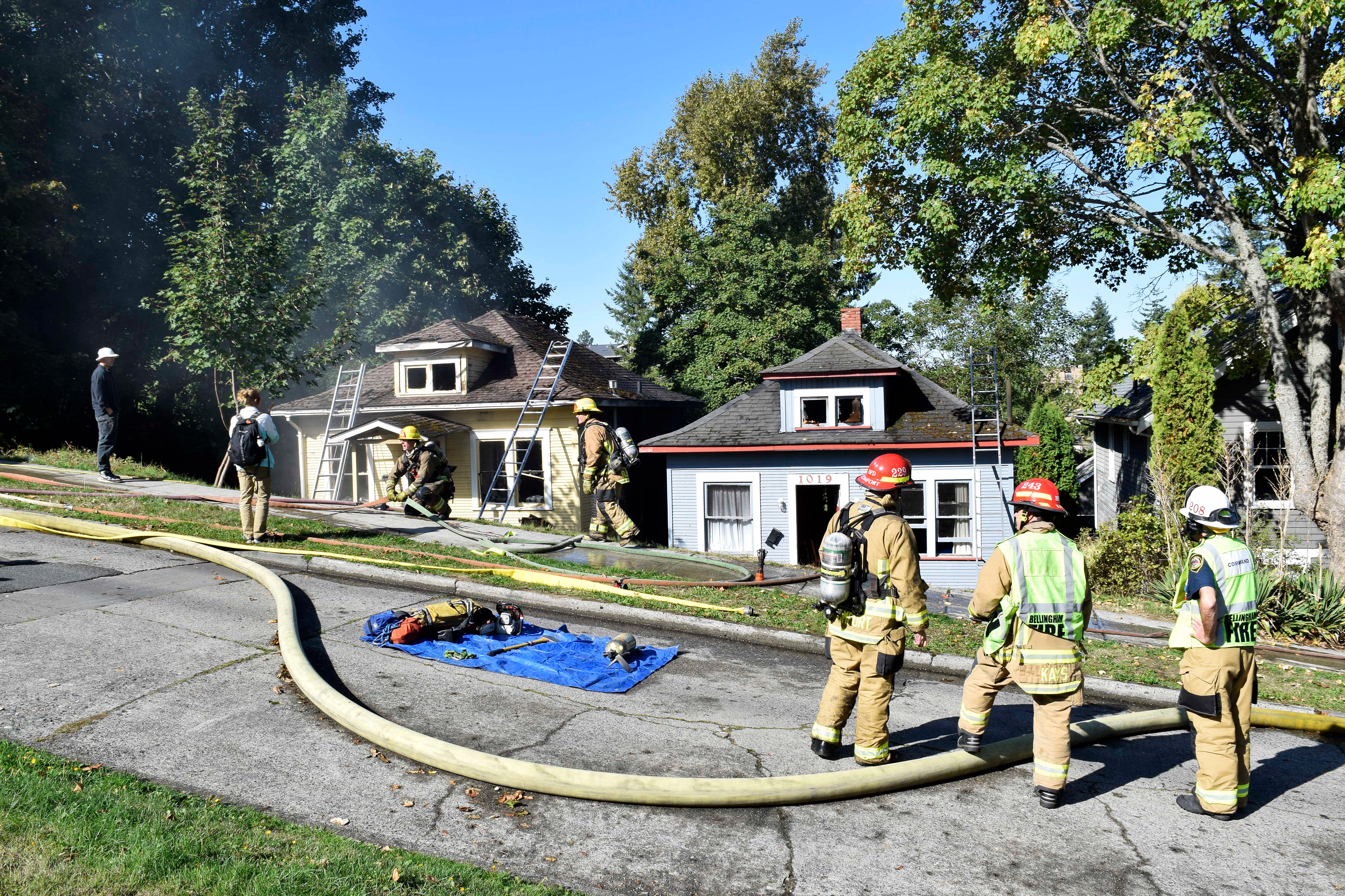 Firefighters and residents observe the aftermath of a house fire at 1017 Jersey St. in Bellingham, Wash. on Oct. 5, 2017.