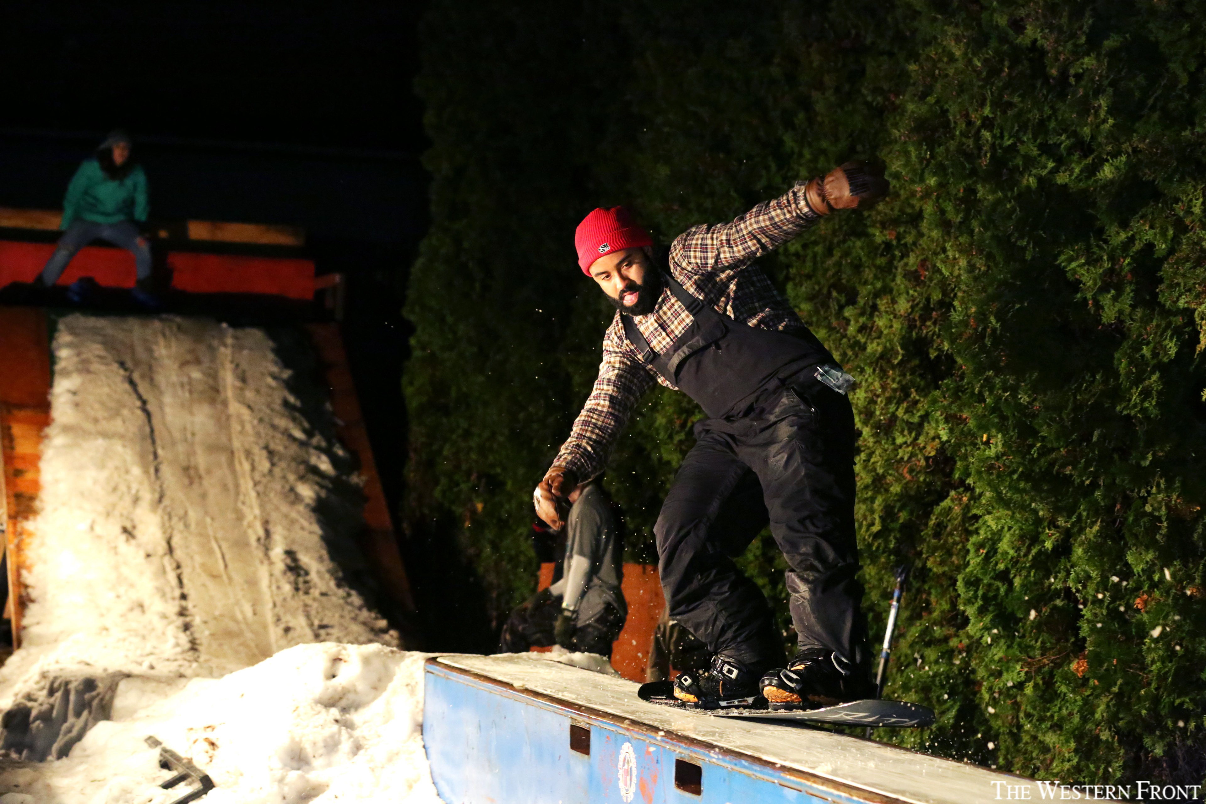 Snowboarder Max Dre shreds across a flat box at the fourth annual Box Jam at Boardworks Tech Shop on Dec. 2, 2017. Boardworks filled their parking lot with snow for the snowboarding party.