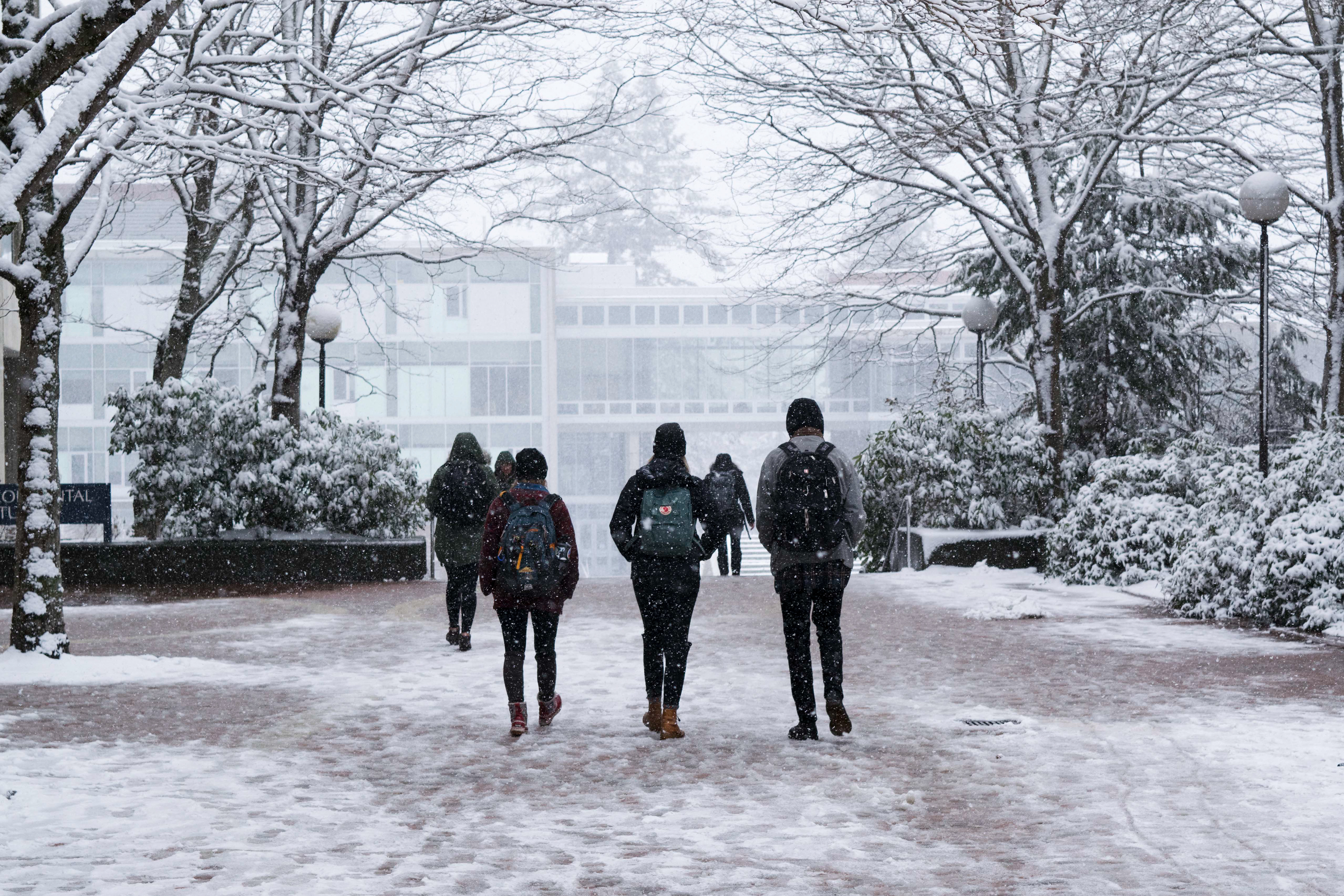 Students walk through a snow covered campus at Western Washington University on Feb. 27, 2017.
