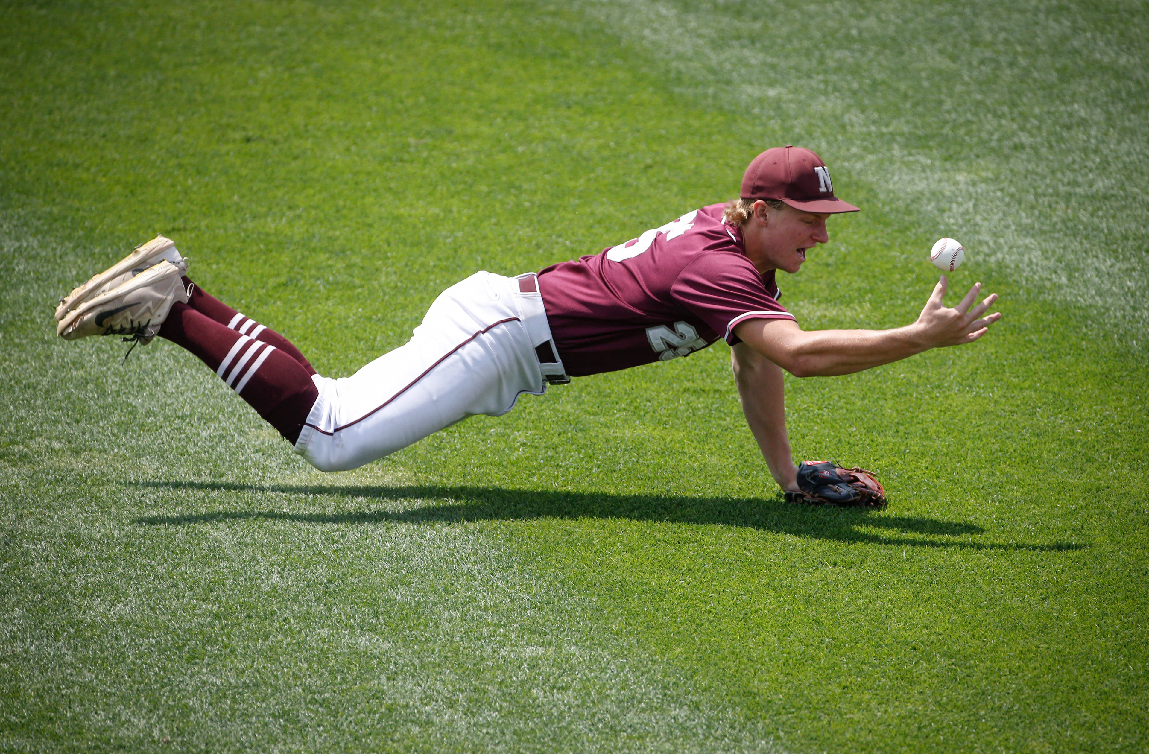 Mason City Newman senior outfielder Jacob Schutt reaches for the ball against Alburnett in the Iowa Class 1A state baseball championship game on Saturday, Aug. 3, 2019, at Principal Park in Des Moines.