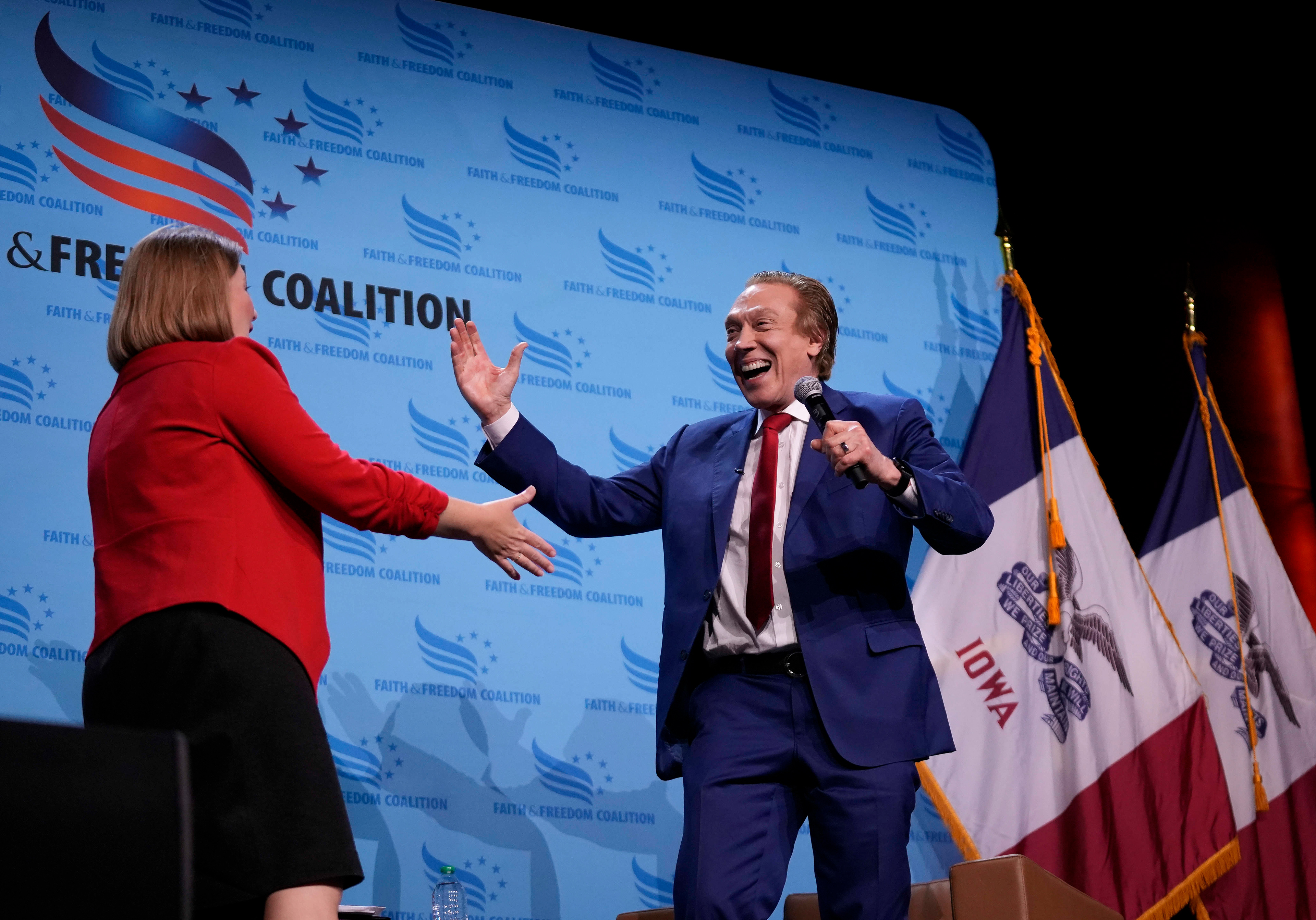 Republican presidential candidate author Perry Johnson hugs Iowa Attorney Gen. Brenna Bird after speaking at the Iowa Faith & Freedom Coalition’s fall banquet, Saturday, Sept. 16, 2023, in Des Moines, Iowa. (AP Photo/Bryon Houlgrave)