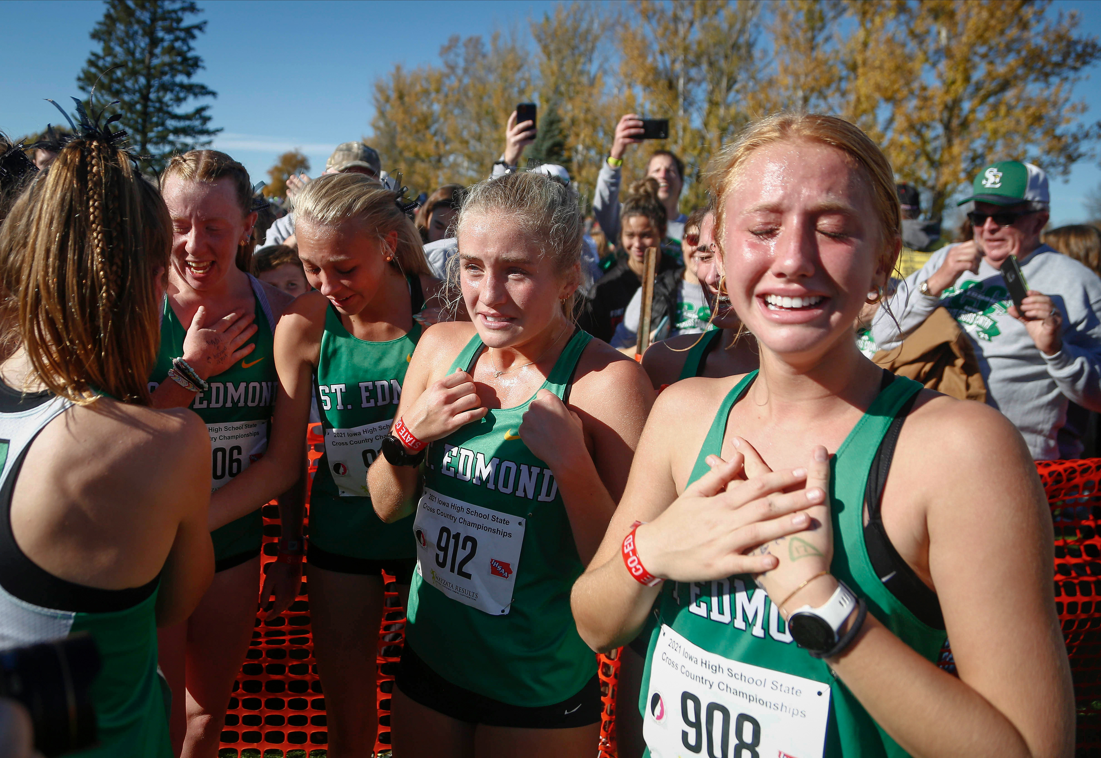 Members of the Fort Dodge St. Edmund girls cross country team react after learning they won the team title during the Class 1A Iowa high school state cross country meet on Saturday, Oct. 30, 2021, in Fort Dodge.