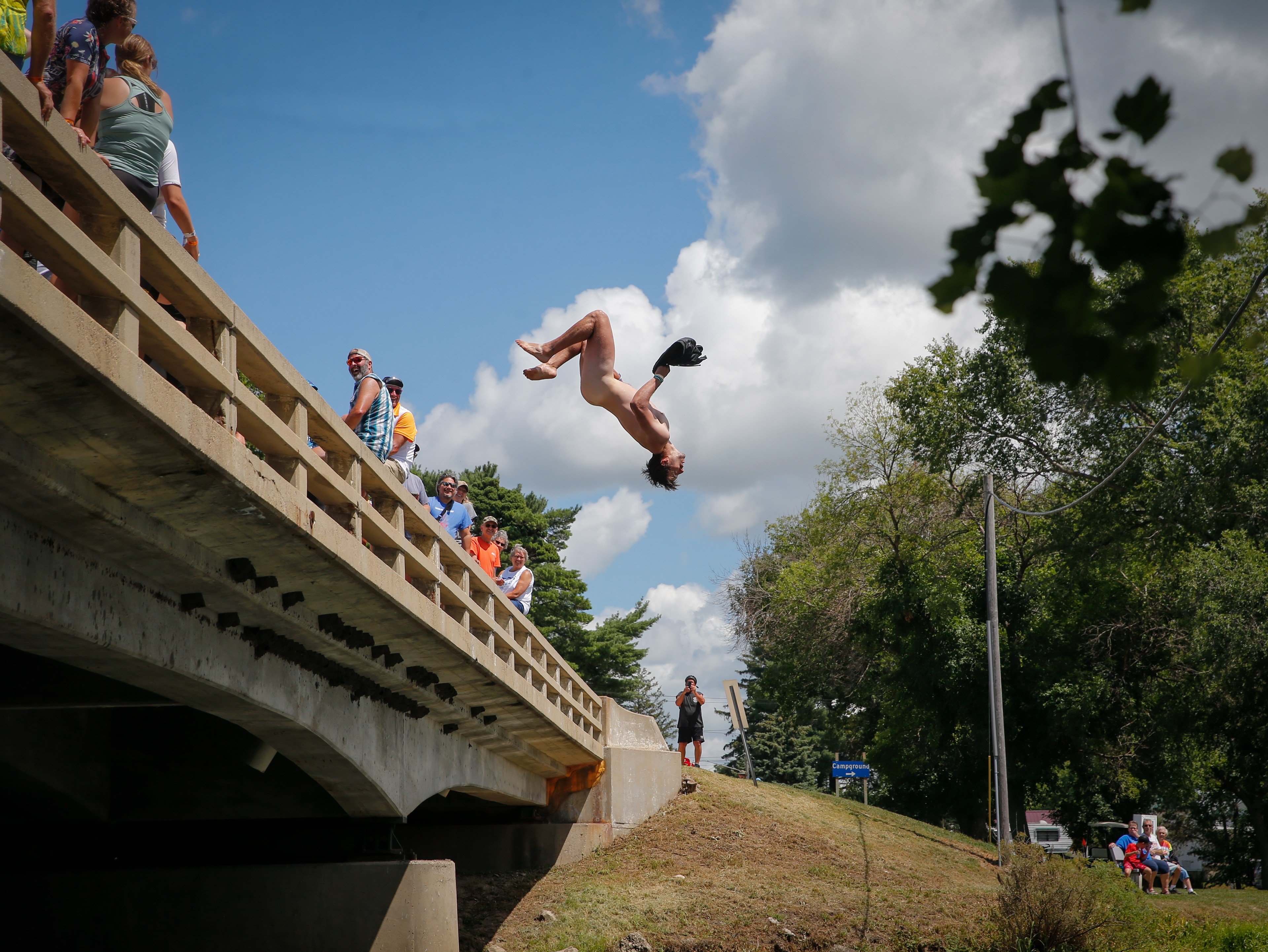 A cyclist strips naked and jumps off a bridge during RAGBRAI on Friday, July 29, 2022.