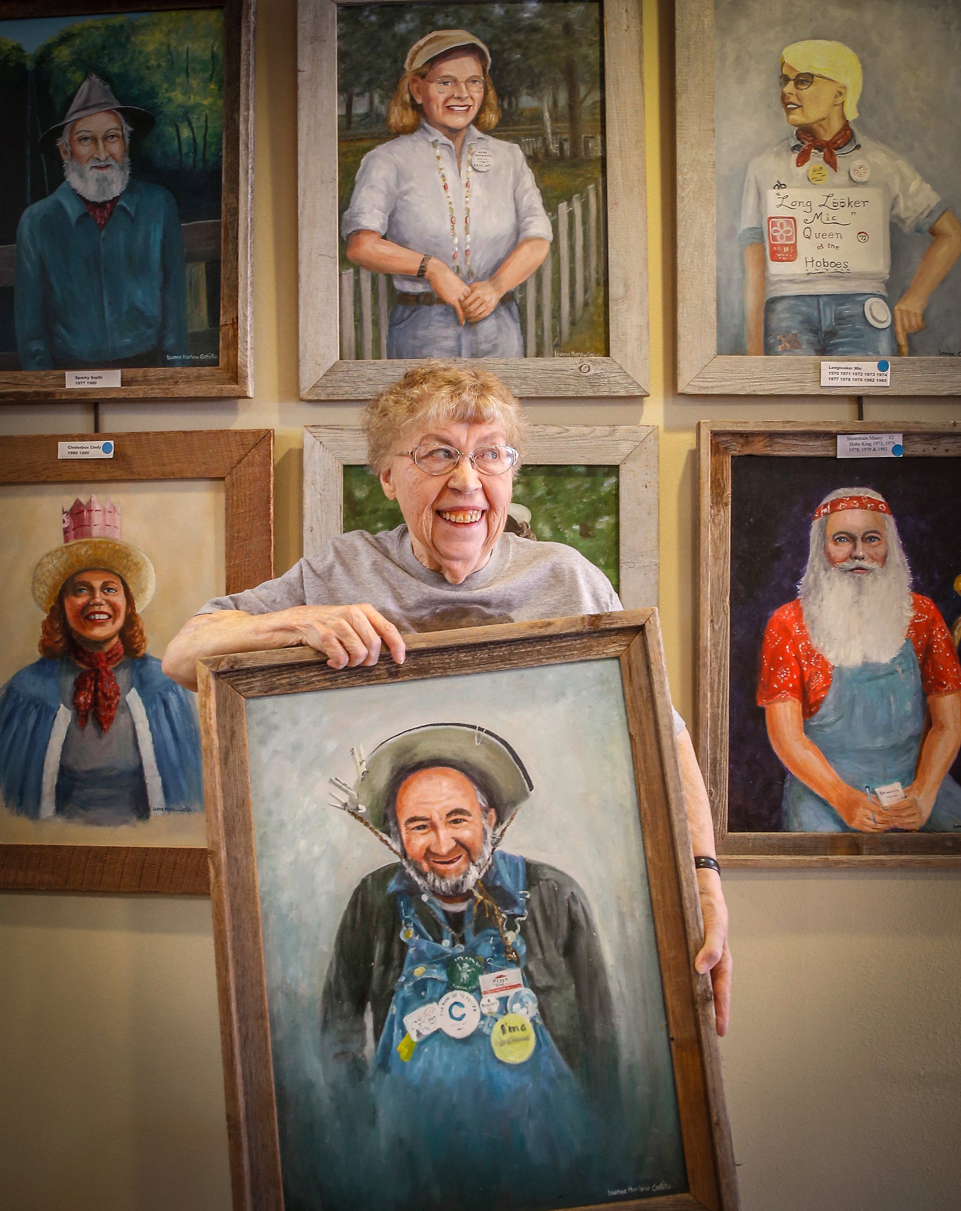 Painter Leanne Castillo of Britt, Iowa, poses for a portrait with some of her hobo paintings on Tuesday, July 25, 2017, at her art gallery in Britt.