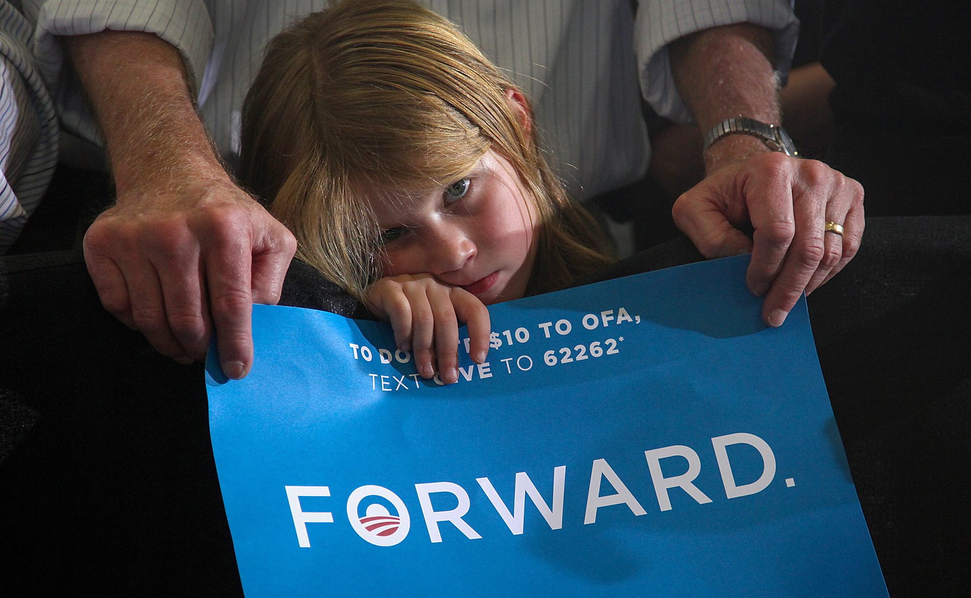Julie Watt, 5, of North Liberty, waits for president Barack Obama to arrive on Wednesday, Oct. 17, 2012, at Cornell College in Mt. Vernon, Iowa.