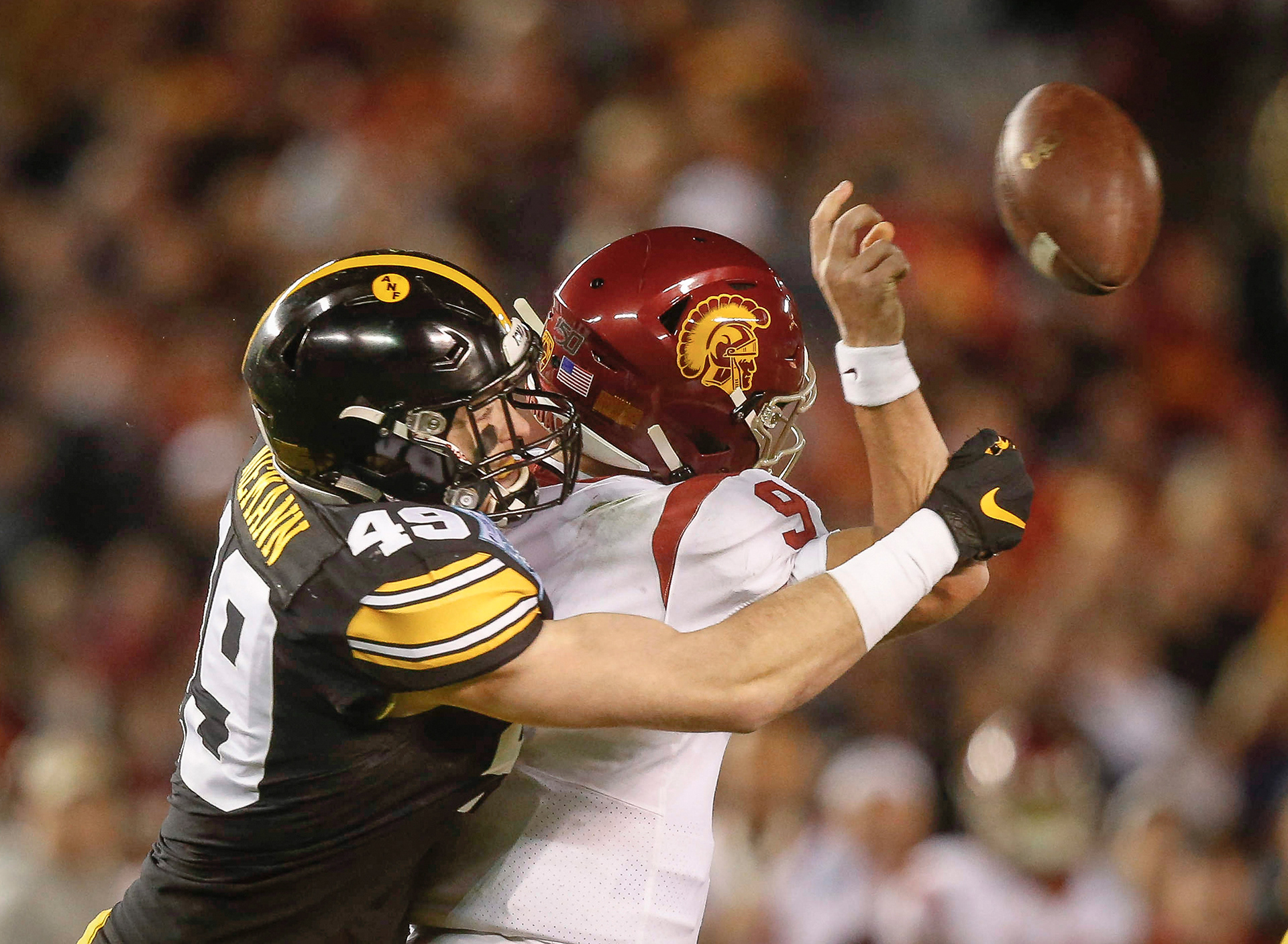 Iowa linebacker Nick Niemann knocks the ball away from USC freshman quarterback Kedon Slovis in the second quarter during the Holiday Bowl on Friday, Dec. 27, 2019, at the SDCCU Stadium in San Diego, Calif.