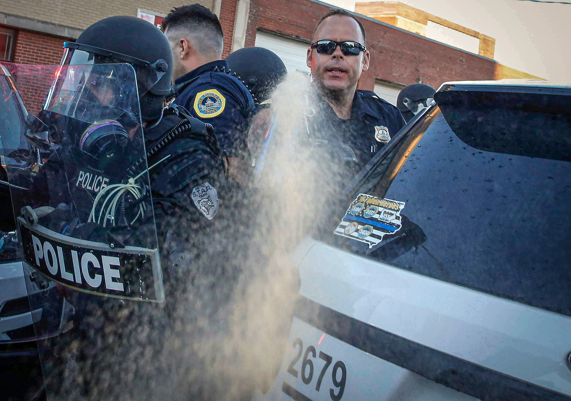 A Des Moines police officer deploys a can of pepper spray at protesters on Friday, May 29, 2020, in Des Moines. The protests were a response to the recent death of George Floyd, a Minneapolis man who was killed by a Minneapolis police officer. 