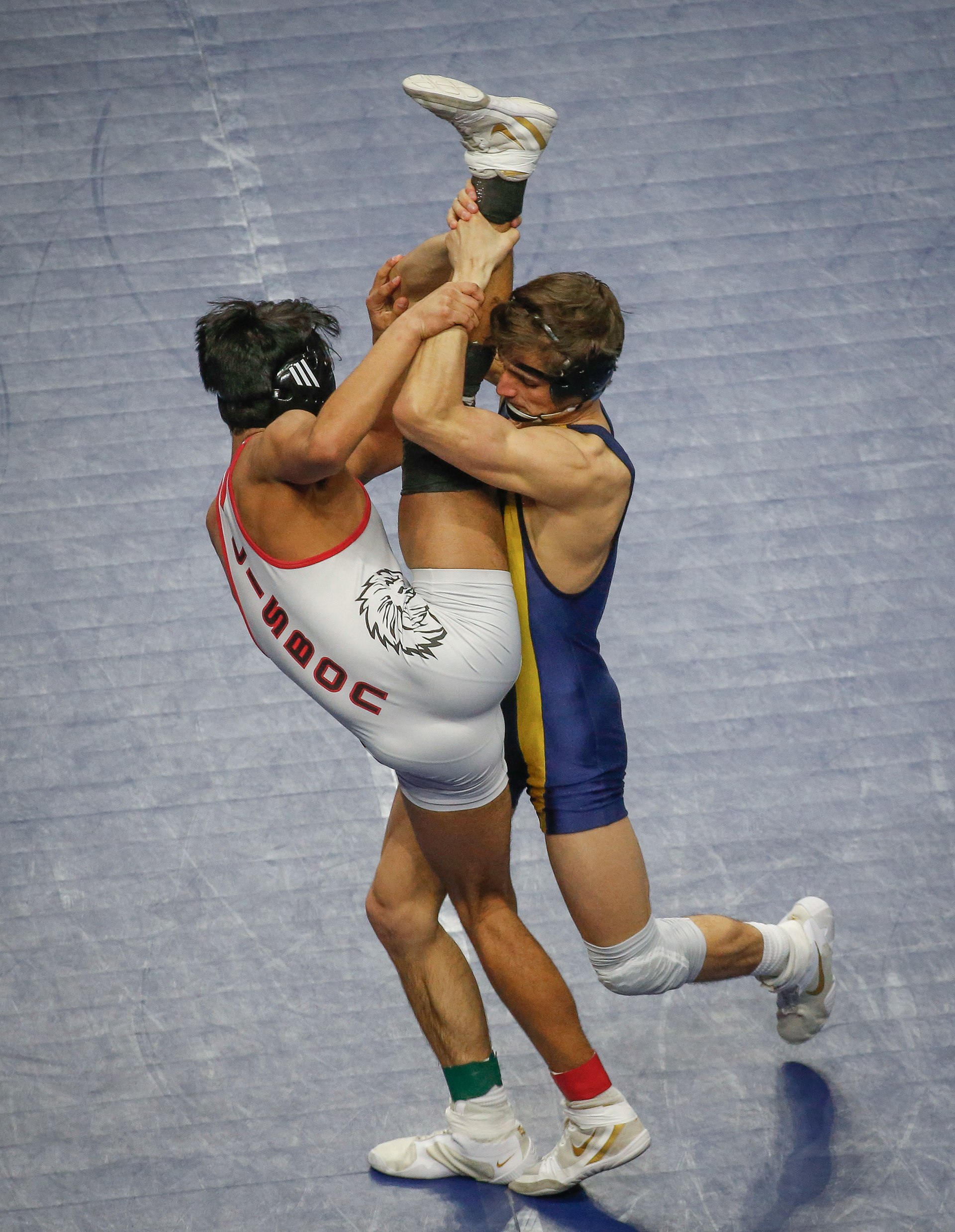 Hudson senior Karter Krapfl pushes the leg of Lisbon junior Indy Harbaugh high into the air in their Class 1A match at 145 match during the Iowa high school state wrestling tournament at Wells Fargo Arena in Des Moines on Thursday, Feb. 17, 2022.