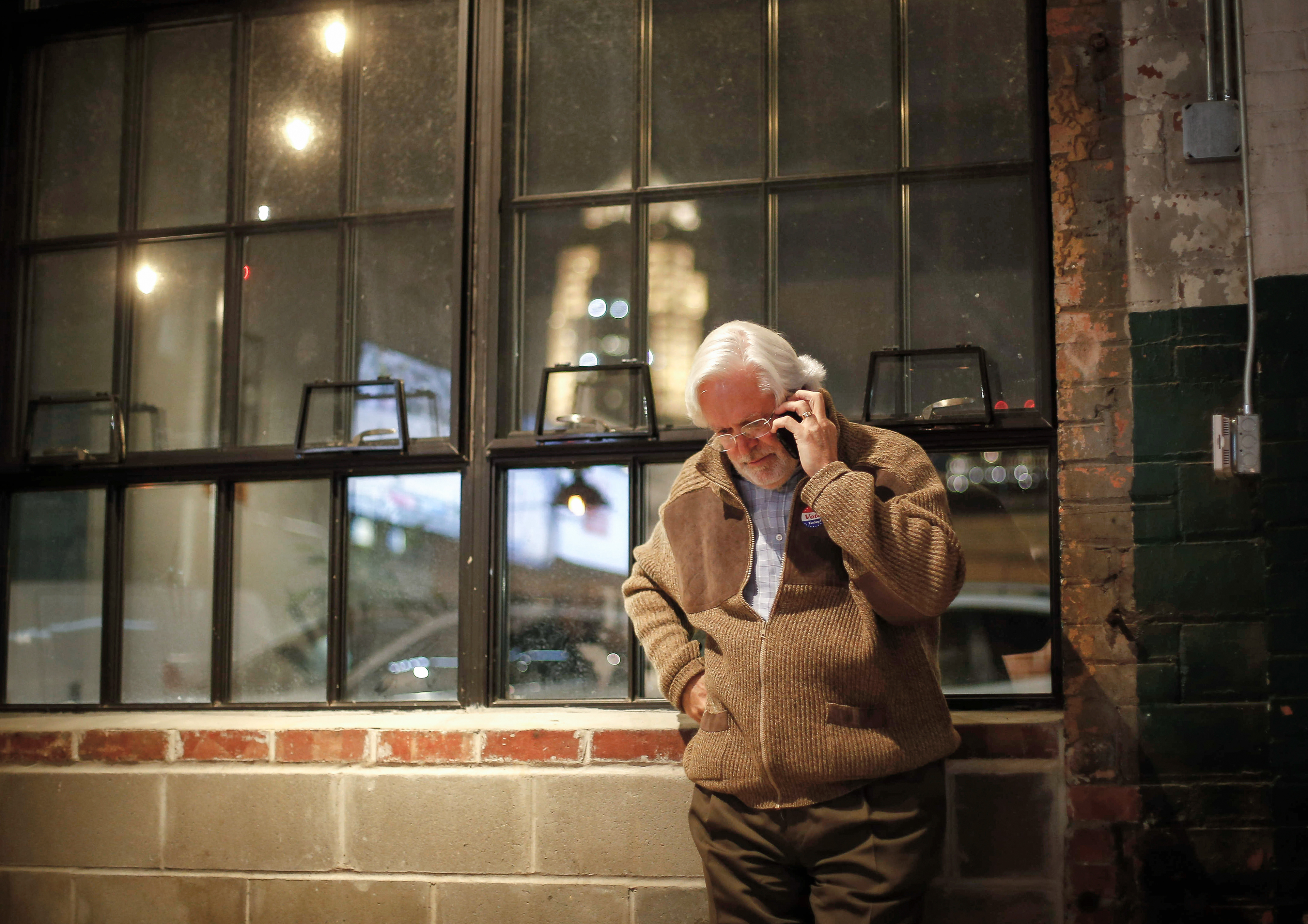 Des Moines mayoral candidate Jack Hatch takes a telephone call while waiting for polls to close during a runoff election party at The Walnut in Des Moines on Tuesday, Dec. 3, 2019.