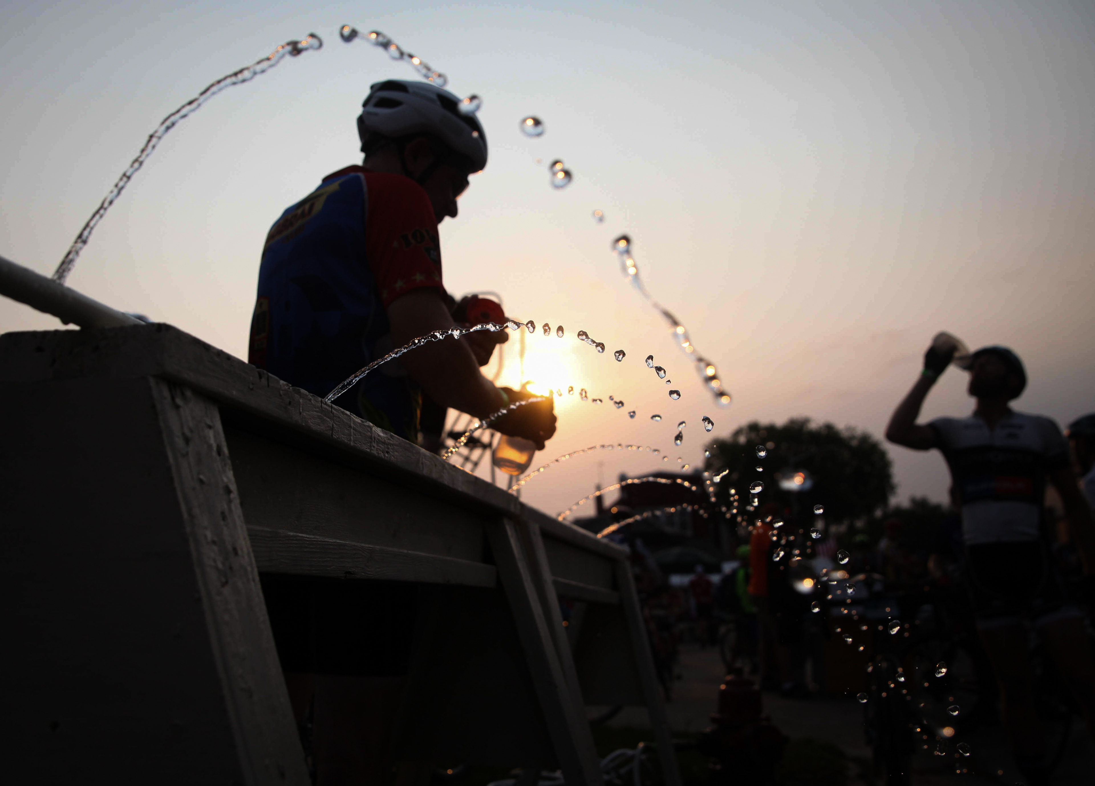 Cyclists refill their water bottles in the town of Ackley, the first stop of RAGBRAI on Wednesday, July 28, 2021.