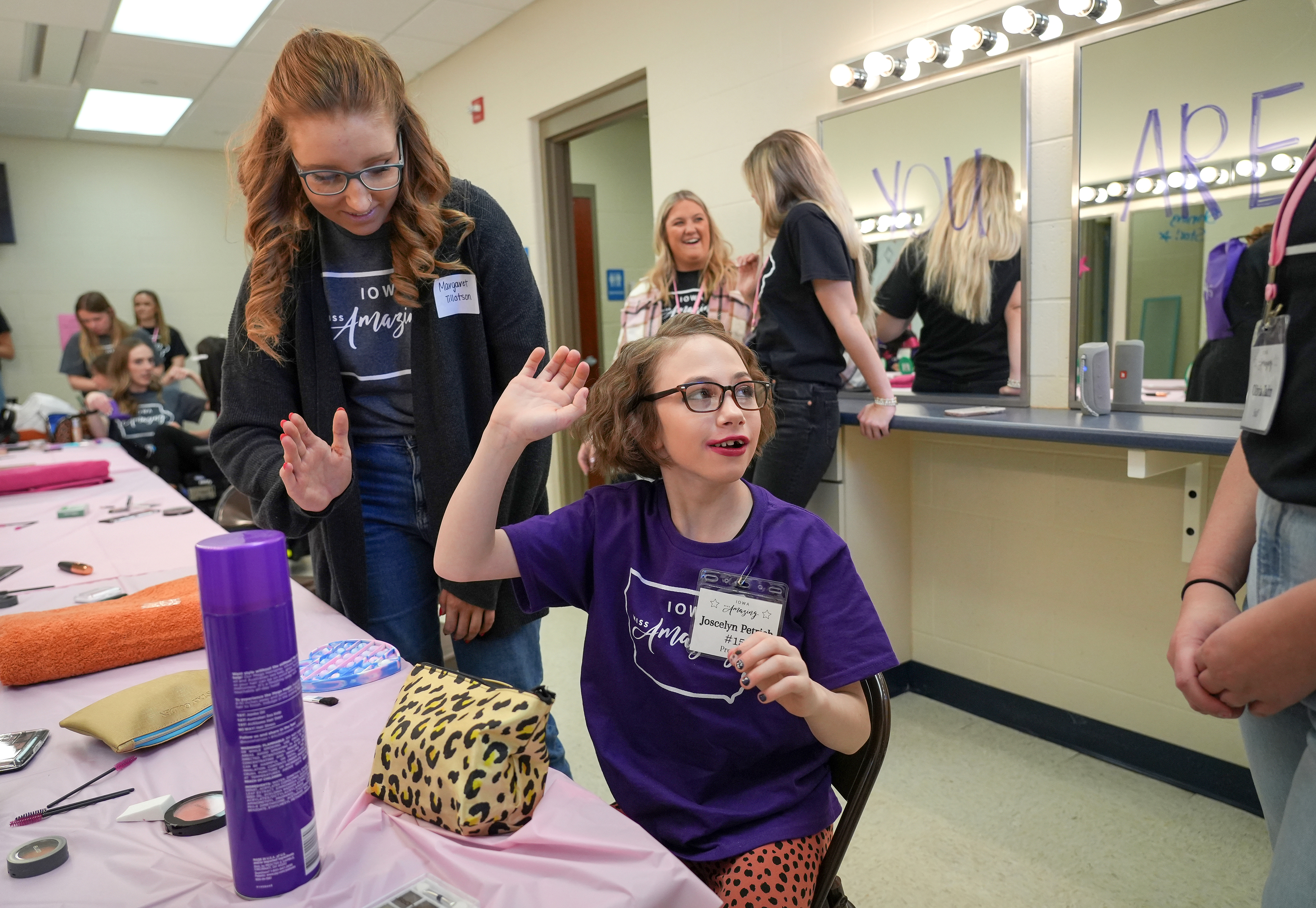 Iowa Miss Amazing preteen participant Joscelyn Petrich sits down at a stylist booth to get her hair and makeup done prior to her passion presentation during the 11th annual Iowa Miss Amazing pageant at the Urbandale High School auditorium in Urbandale, Iowa, on Saturday, Feb. 4, 2023. 