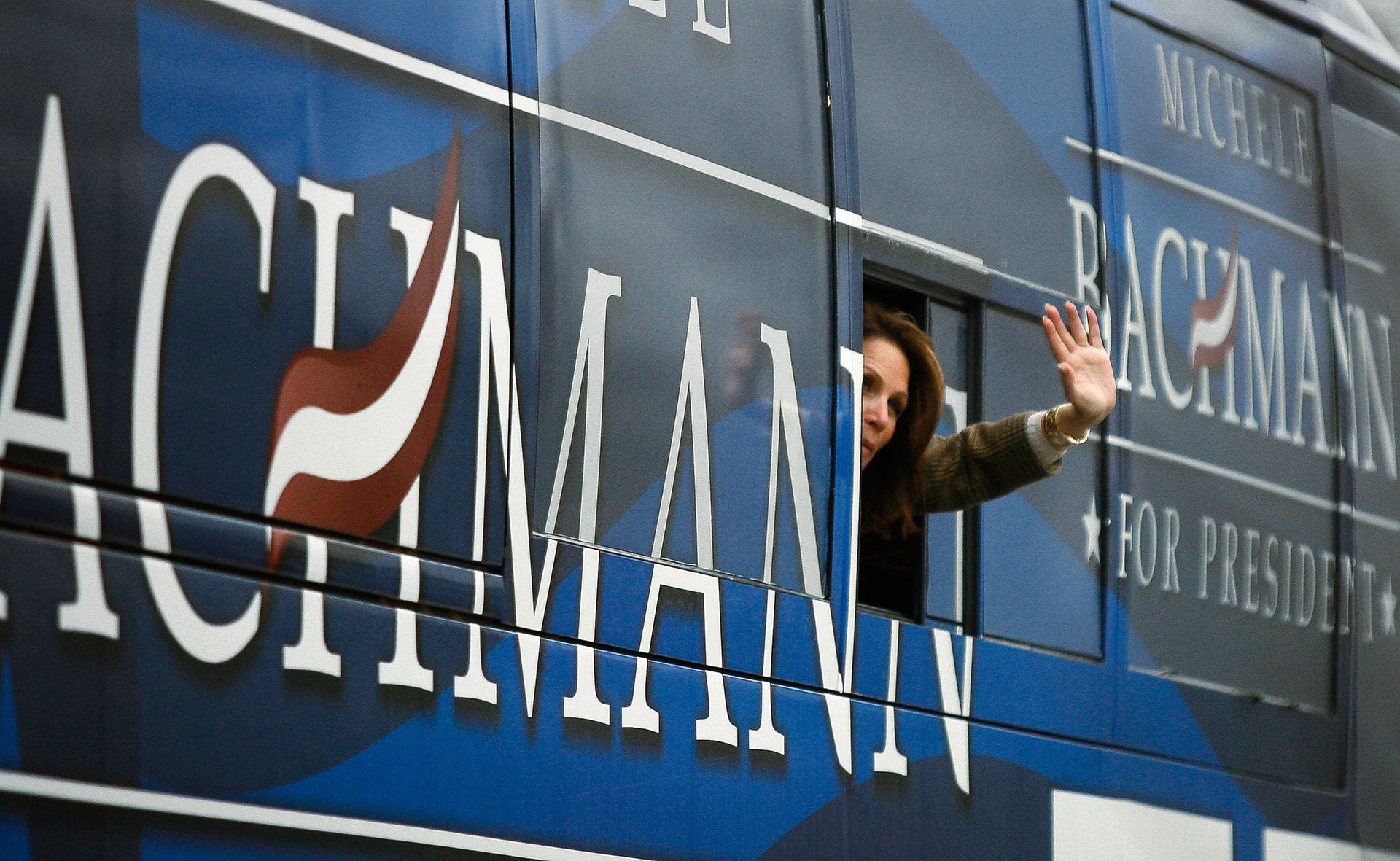 Republican presidential candidate Michele Bachmann waves goodbye as her bus pulls away from the Central Perk Coffee and Dessert shop in Fort Dodge, Iowa, on Friday, Dec. 30, 2011.
