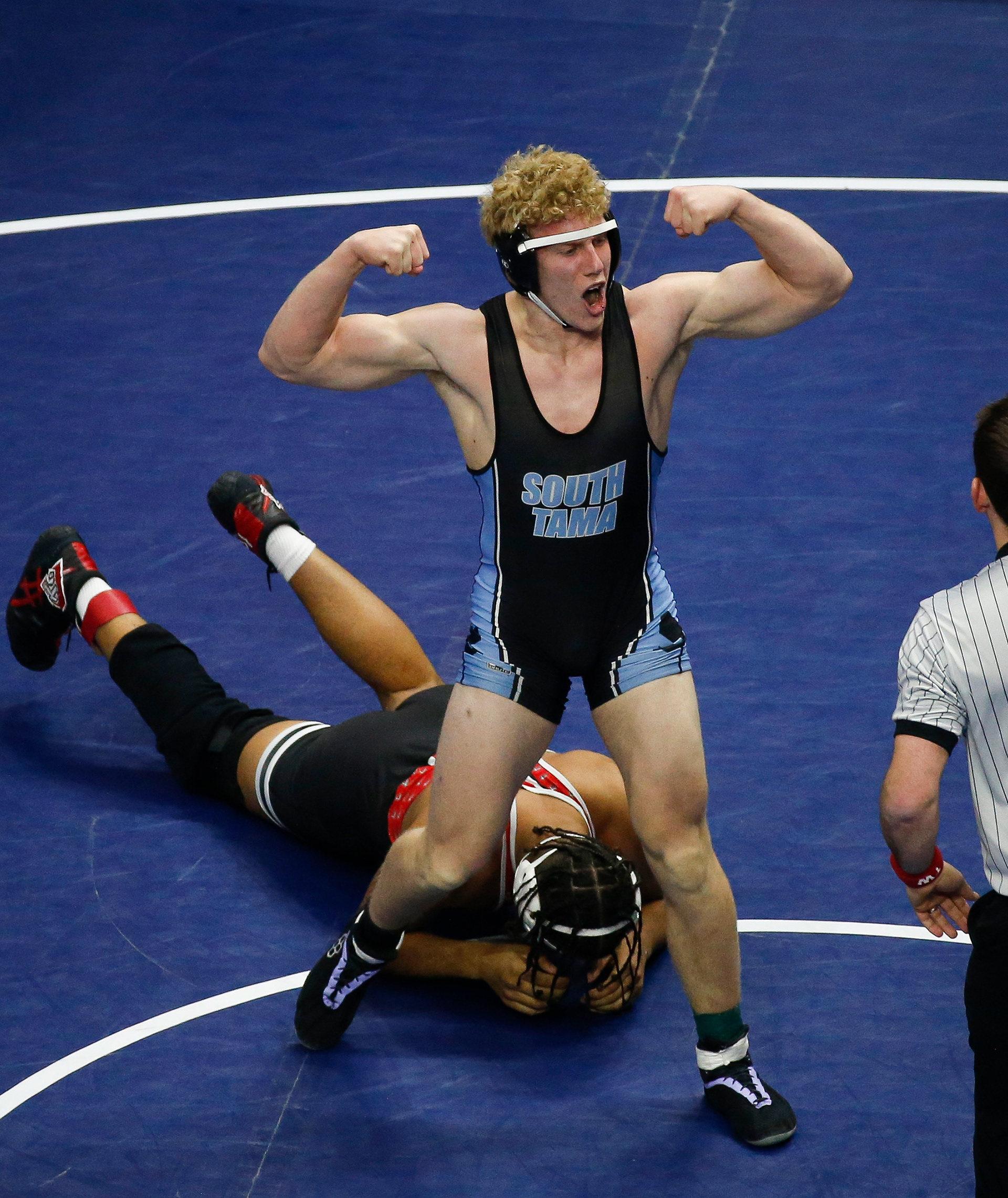 South Tama County sophomore Gavin Bridgewater celebrates a Class 1A semifinal win over Davenport Assumption senior Aiden Morgan in their match at 220 pounds during the Iowa high school state wrestling tournament at Wells Fargo Arena in Des Moines on Friday, Feb. 18, 2022.