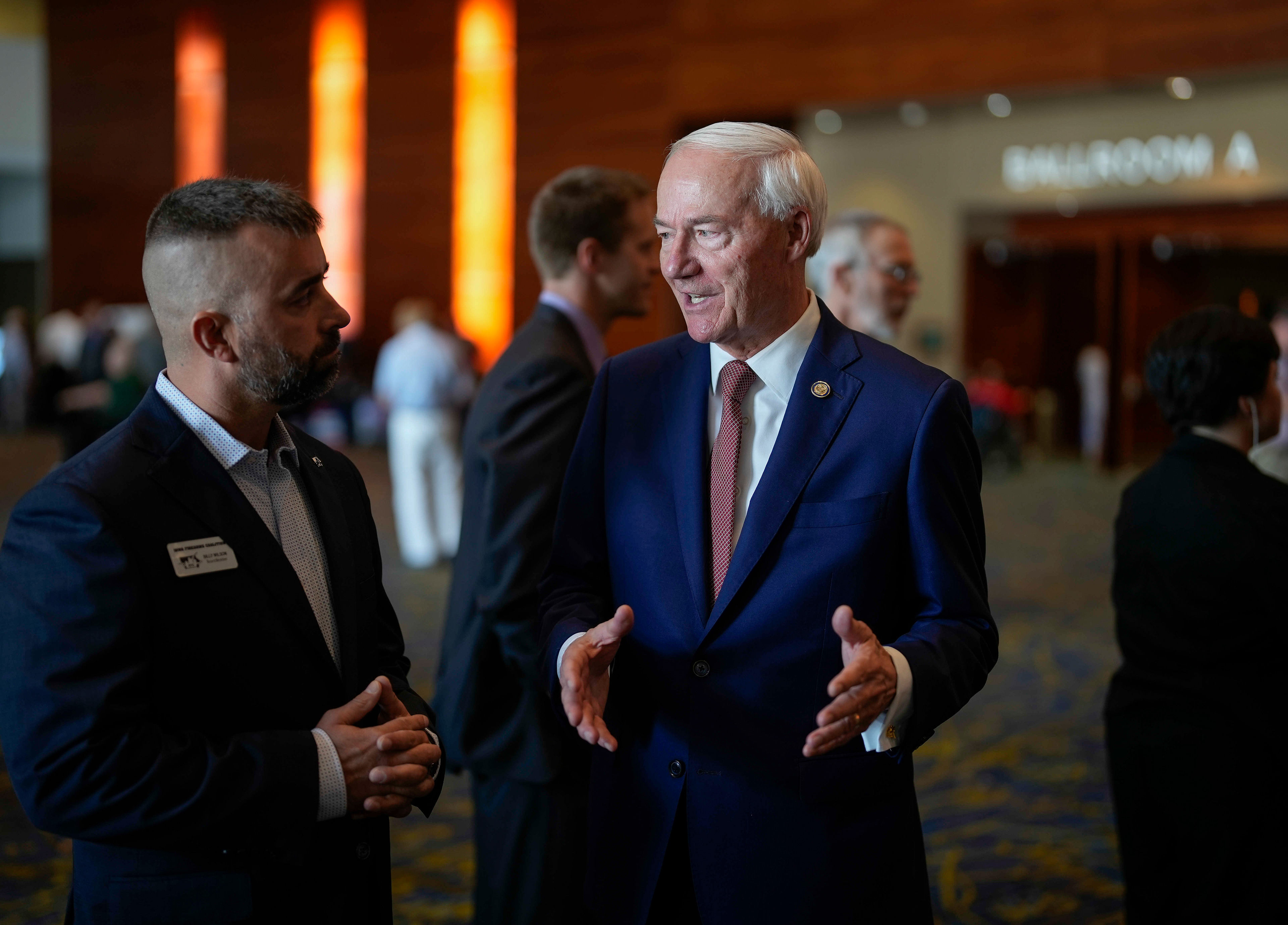 Republican presidential candidate former Arkansas Gov. Asa Hutchinson, right, speaks with Billy Wilson of the Iowa Firearms Coalition at The Iowa Faith & Freedom Coalition’s fall banquet, Saturday, Sept. 16, 2023, in Des Moines, Iowa. (AP Photo/Bryon Houlgrave)