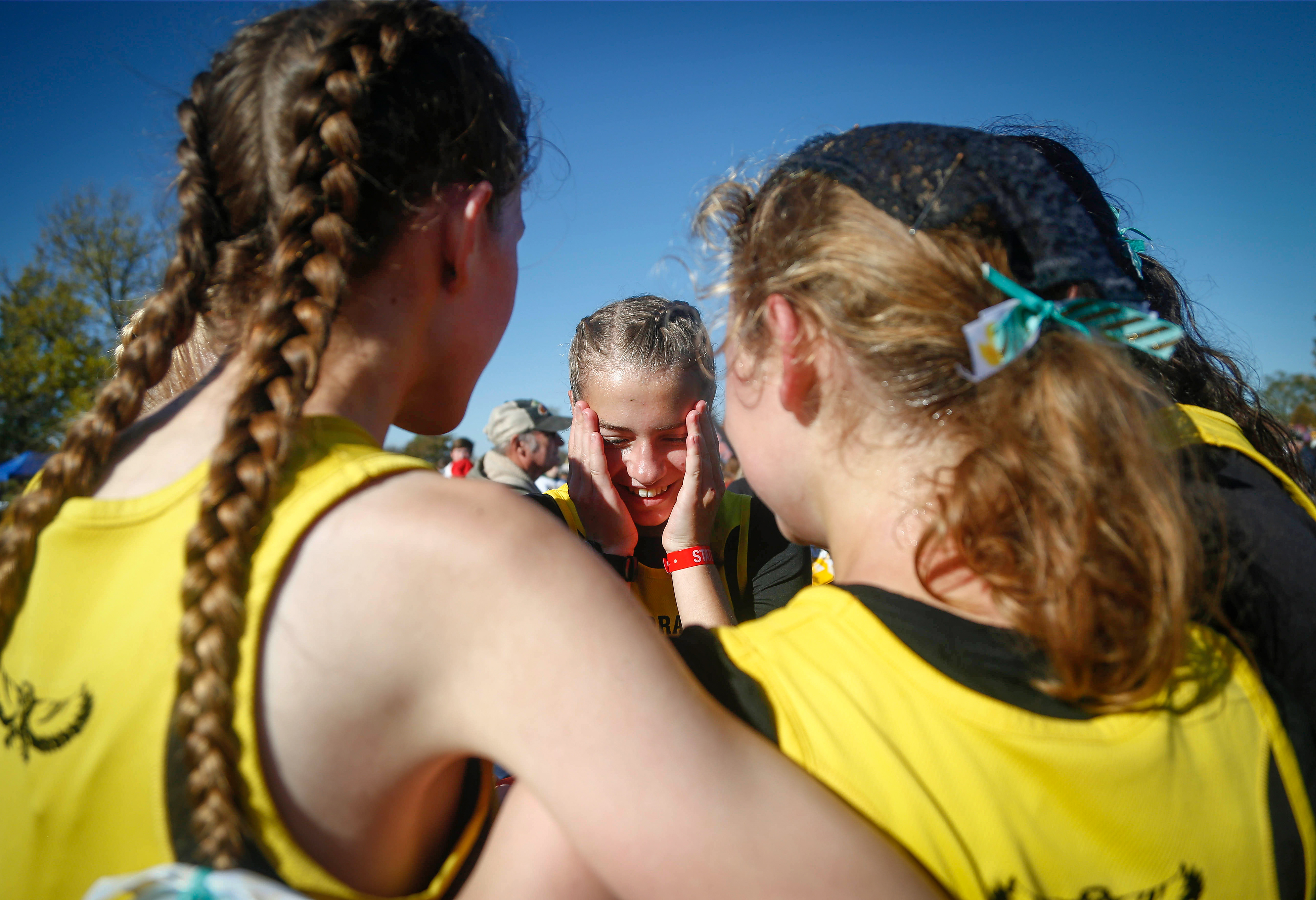 Members of the Mid-Prairie, Wellman girls cross country team celebrate after learning they won the team championship during the Class 2A Iowa high school state cross country meet on Saturday, Oct. 30, 2021, in Fort Dodge.