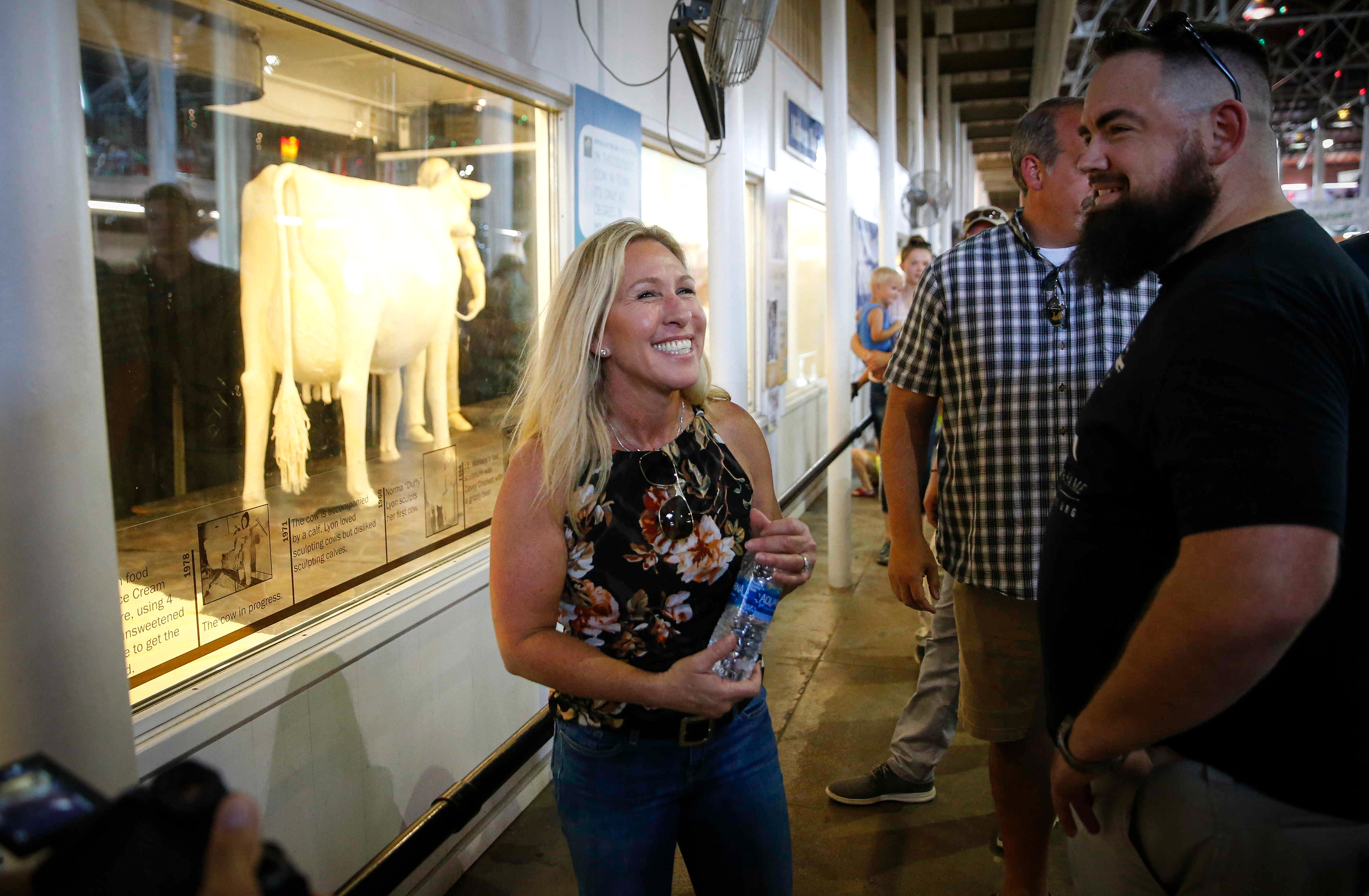 U.S. Rep. Marjorie Taylor Greene (R-Georgia) stops to look at the Butter Cow in the Agriculture Building during the Iowa State Fair on Thursday, Aug. 19, 2021, in Des Moines, Iowa. 