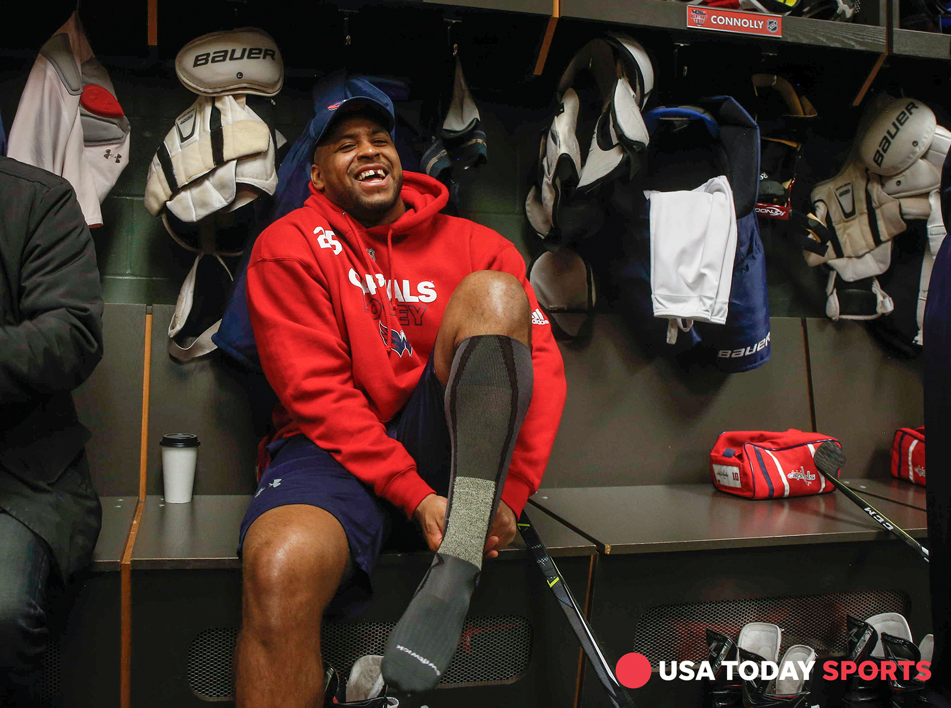Washington Capitals right wing Devonte Smith-Pelly laughs as fathers of the players joke around prior to practice on Thursday, Feb. 15, 2018, in St. Paul, Minn., during the 2018 Mentors' Trip.