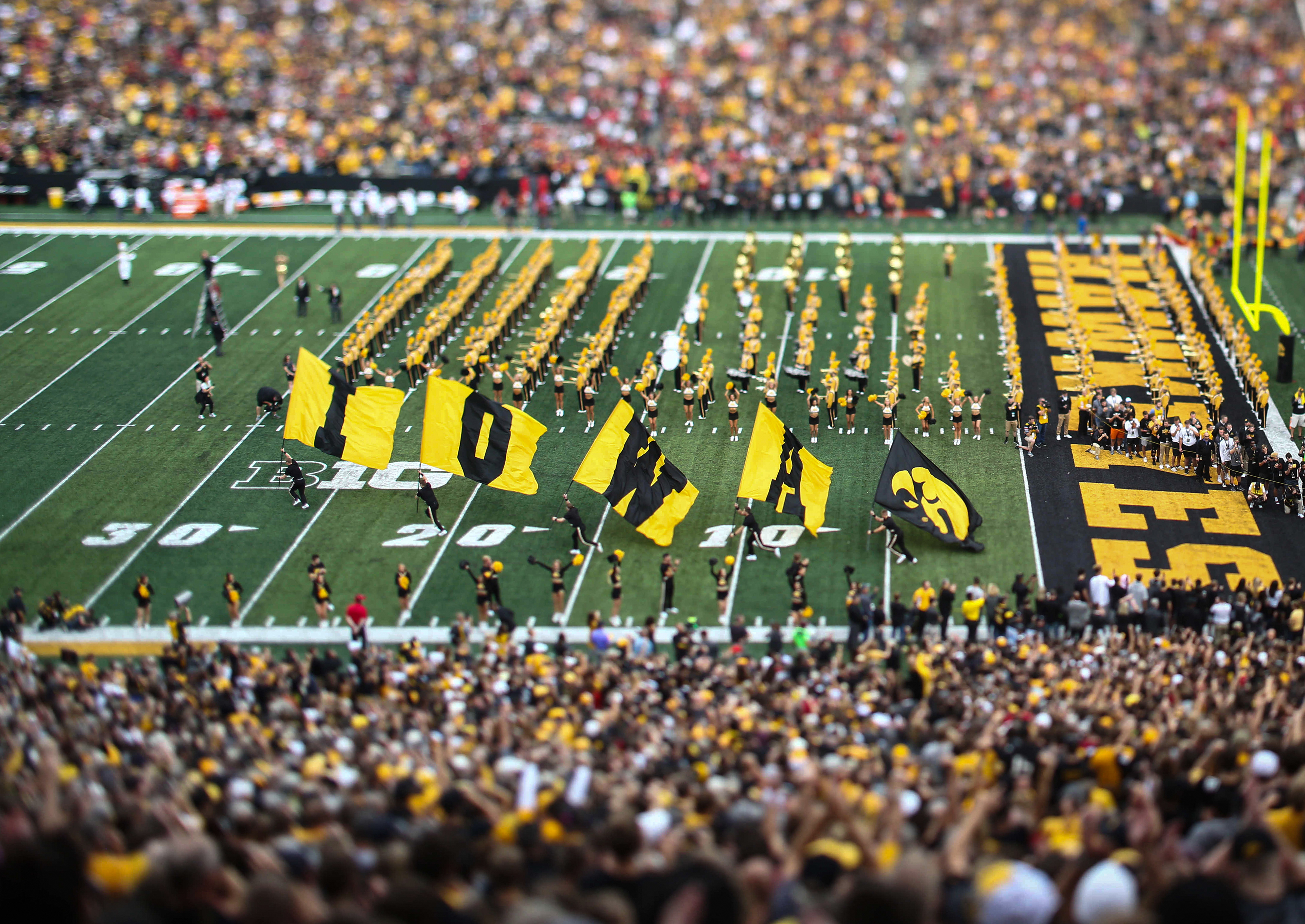 Members of the Iowa Spirit Squad run the Iowa flags onto the field prior to kickoff against Iowa State on Saturday, Sept. 8, 2018, at Kinnick Stadium in Iowa City.