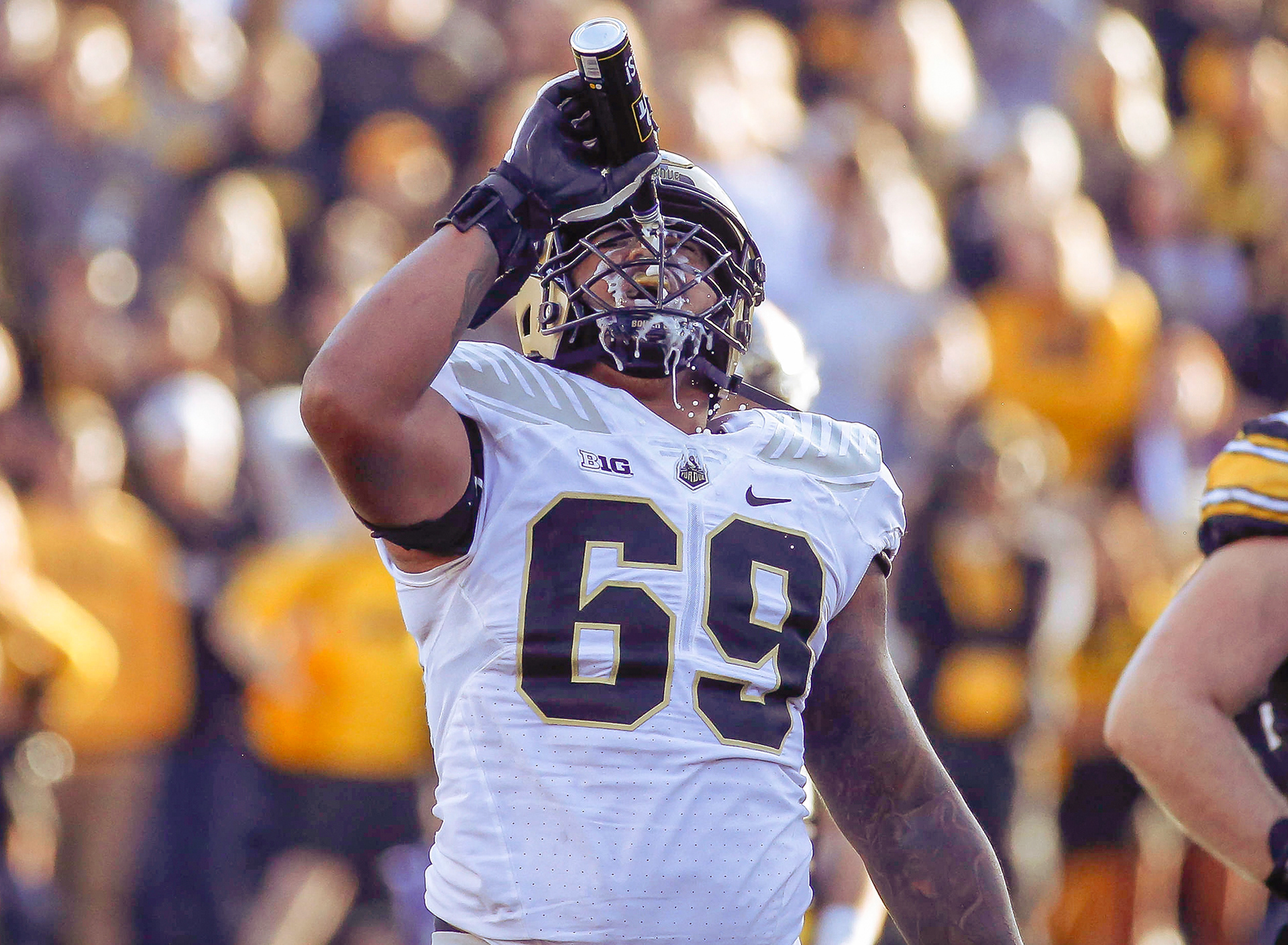 Purdue offensive lineman Greg Long pours a can of Bud Light over his face after an Iowa fan tossed the beer onto the field during play in the third quarter on Saturday, Oct. 16, 2021, at Kinnick Stadium in Iowa City.
