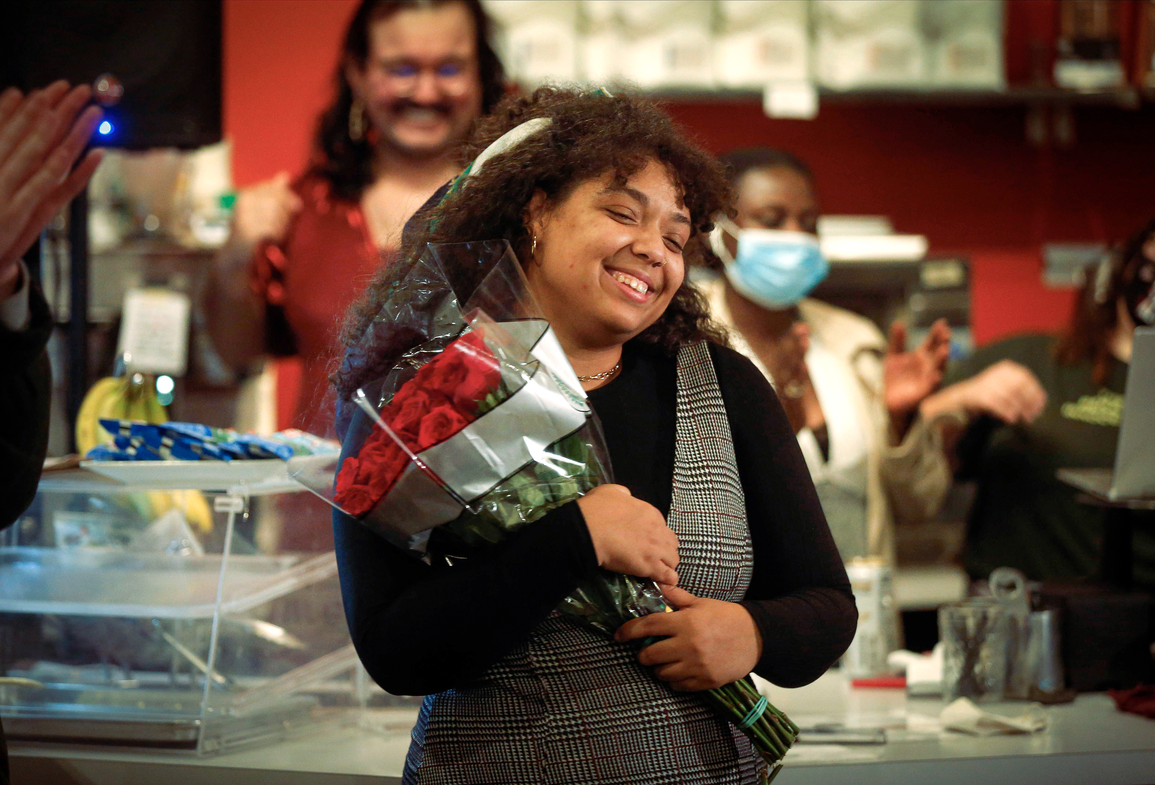 Des Moines City Council candidate Indira Sheumaker holds a bouquet of roses at her election watch party at Mars Cafe on University Ave. in Des Moines on Tuesday, Nov. 2, 2021, after beating incumbent Bill Gray.