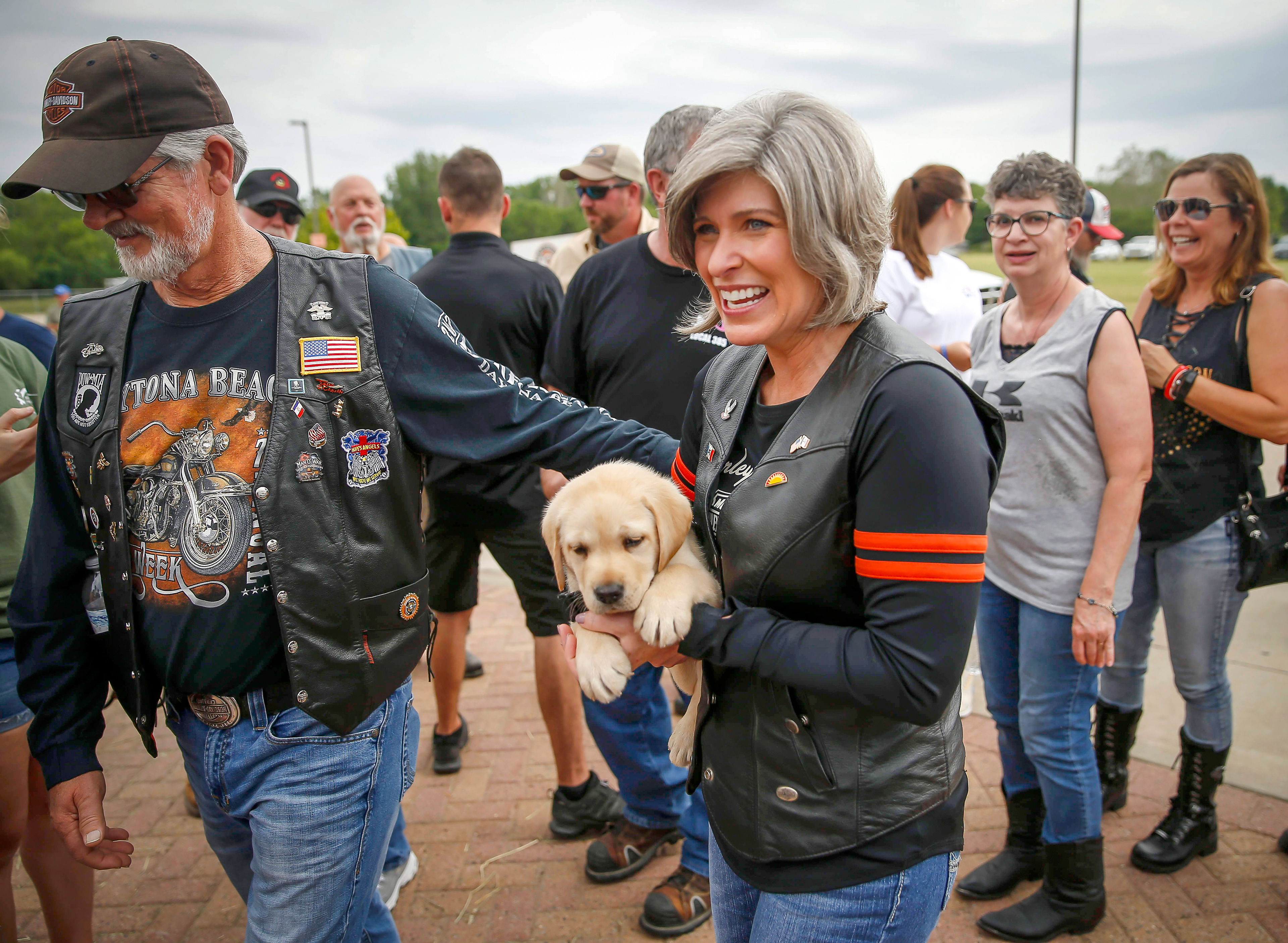 United States Sen. Joni Ernst (R-Iowa) holds a puppy prior to leading the 5th annual Roast and Ride on Saturday, June 14, 2019, in Des Moines.