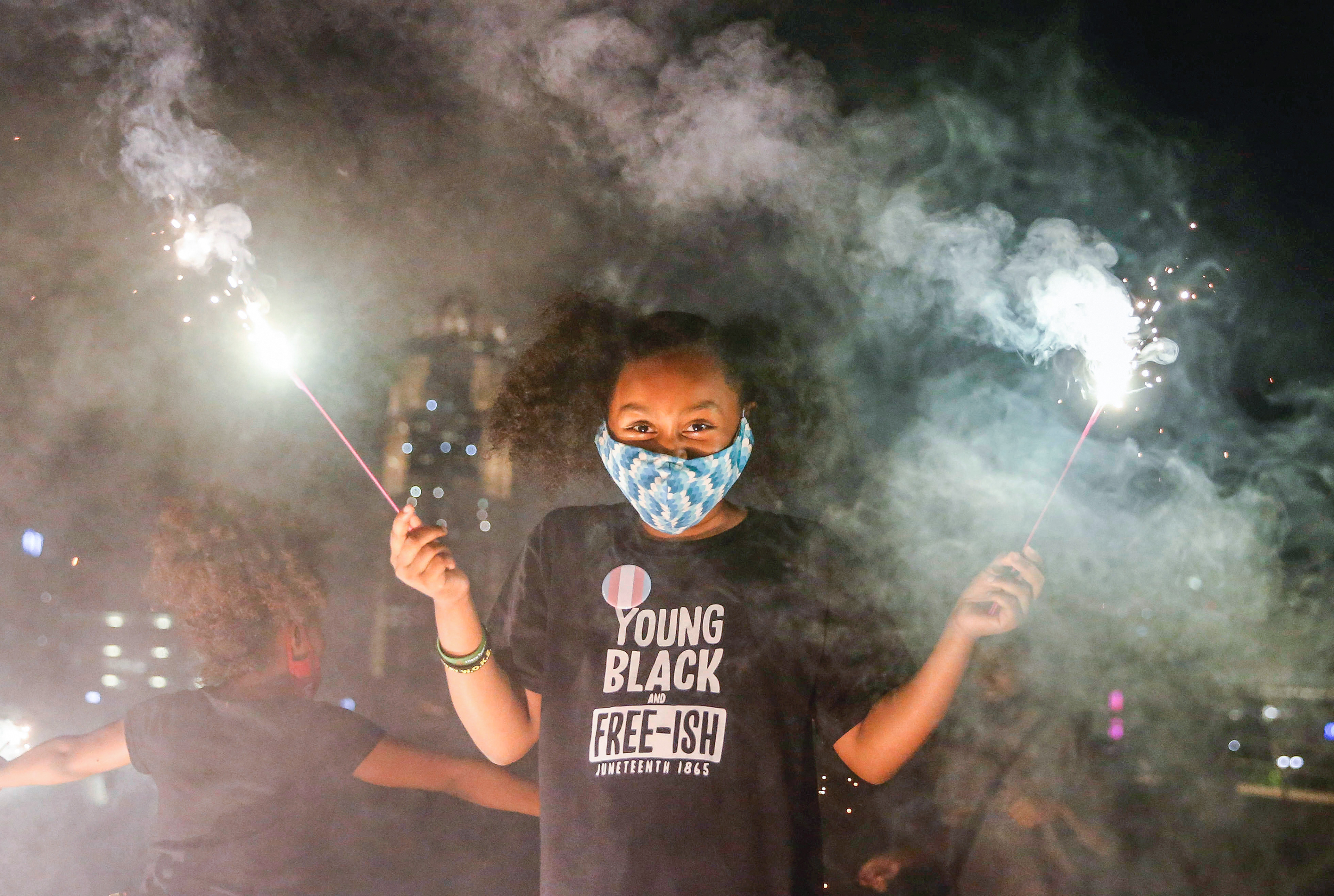Payton Harrington, 9, of Des Moines enjoys playing with sparklers during a Juneteenth celebration in downtown Des Moines. 