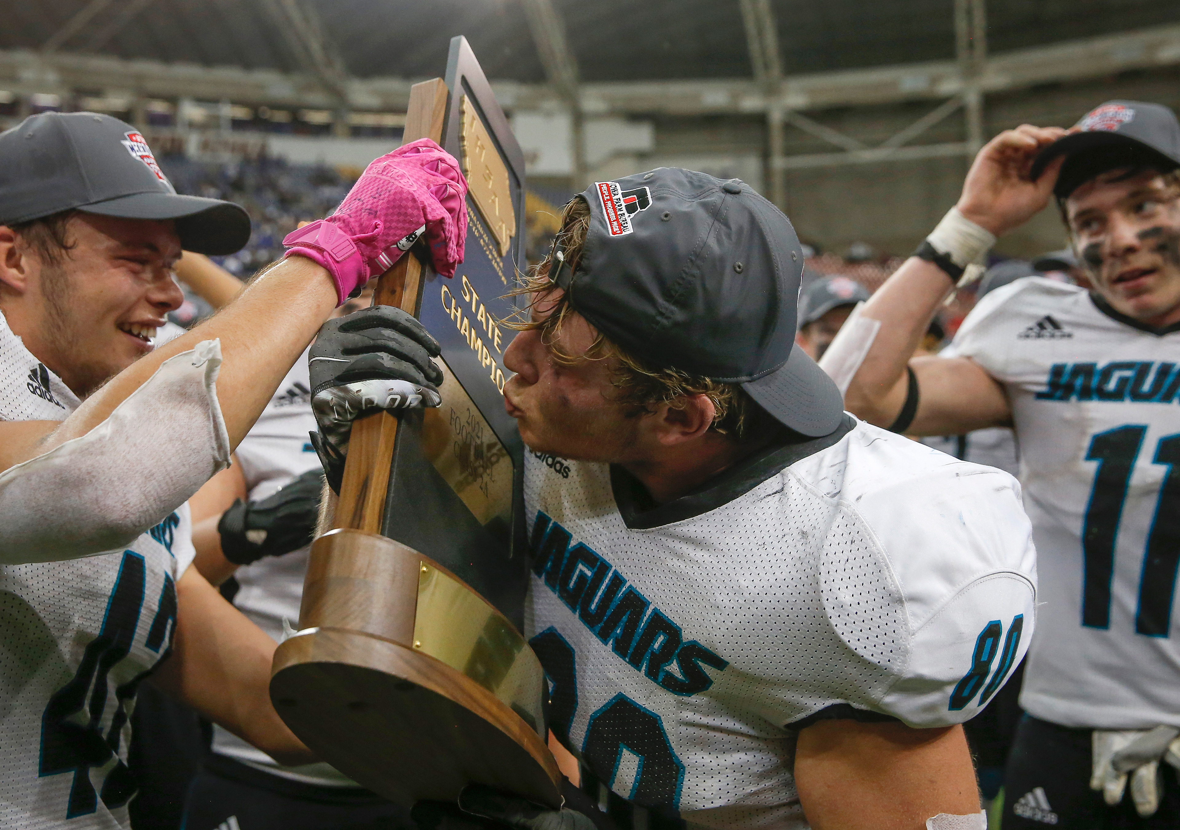 Southeast Valley senior tight end Colton Brant kisses the Class 2A trophy after the Jaguars beat West Lyon, Inwood, during the Iowa High School Class 2A state championship football game at the UNI-Dome in Cedar Falls on Friday, Nov. 19, 2021.