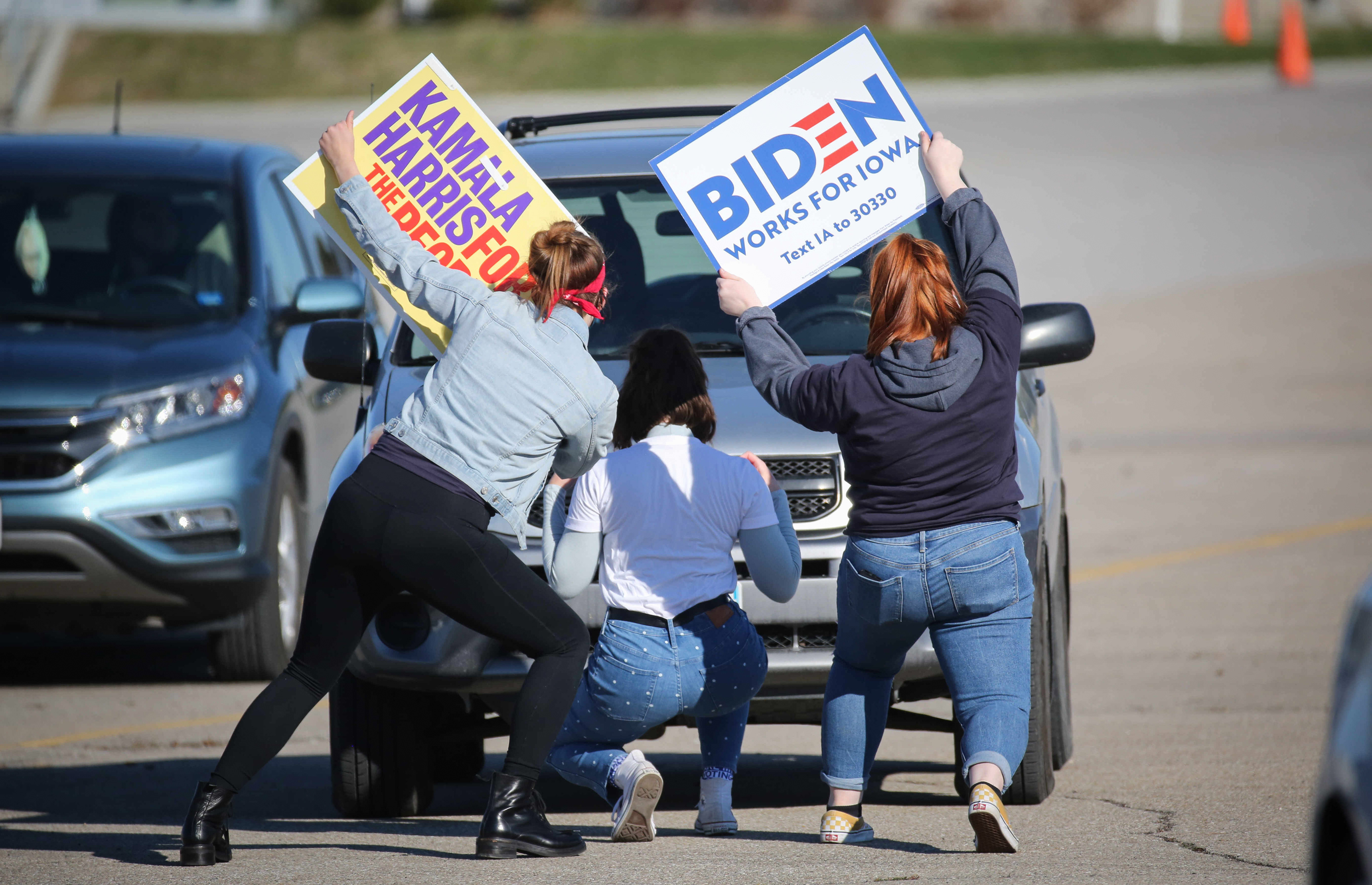 Young supporters of Democratic presidential candidate Joe Biden pose for selfies while they wait for the former Vice President's arrival at the Iowa State Fairgrounds in Des Moines on Saturday, Oct. 30, 2020.