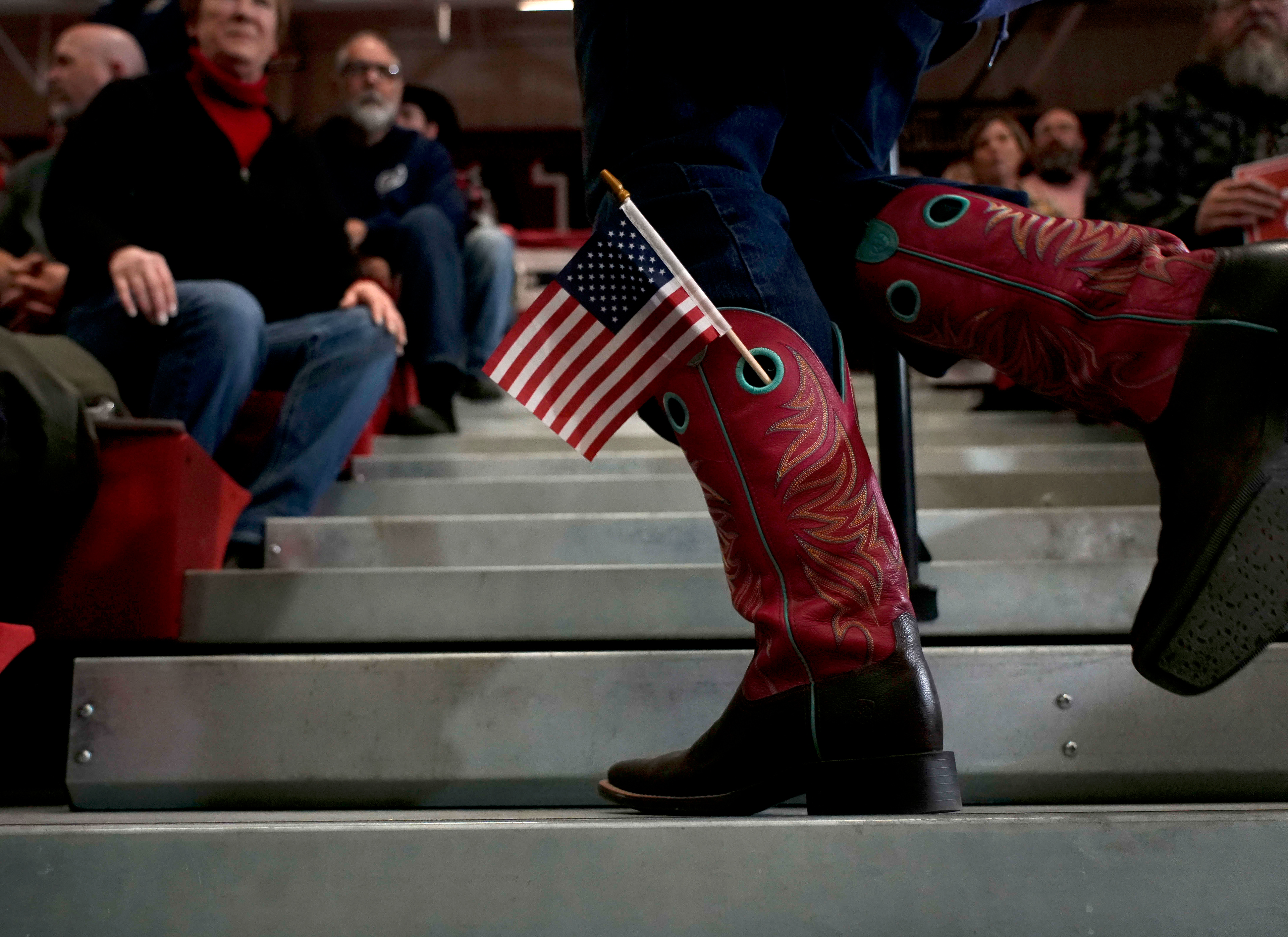 A supporter of Republican presidential candidate and former President Donald Trump wears an American flag in her cowboy boot before Trump spoke during a rally Saturday, Nov. 18, 2023, in Fort Dodge, Iowa. (AP Photo/Bryon Houlgrave)