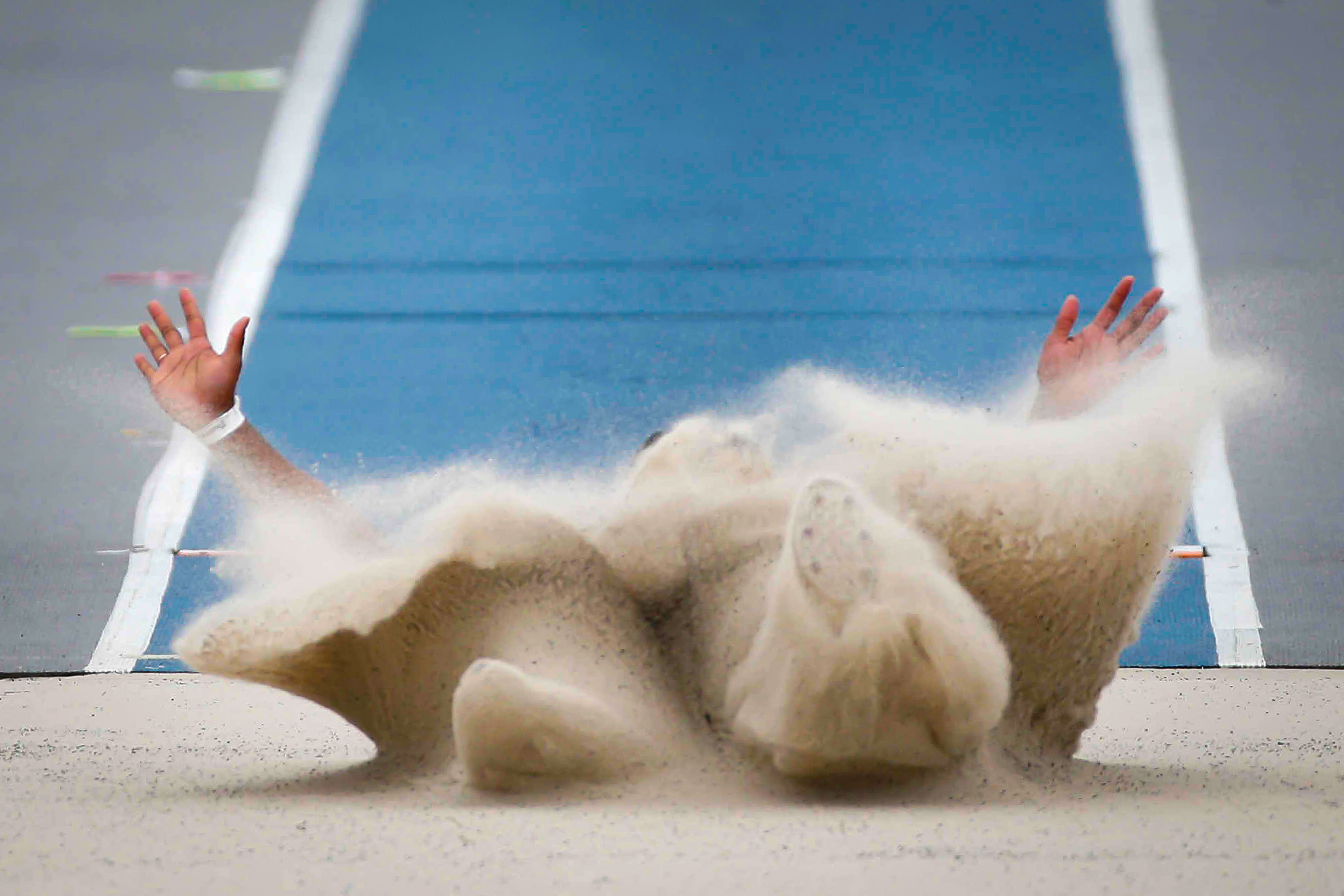 Minnesota State freshman Trinity Moore disappears into the sand pit while competing in the women's long jump during the Drake Relays on Friday, April 23, 2021, at Drake Stadium in Des Moines. Moore won the event.