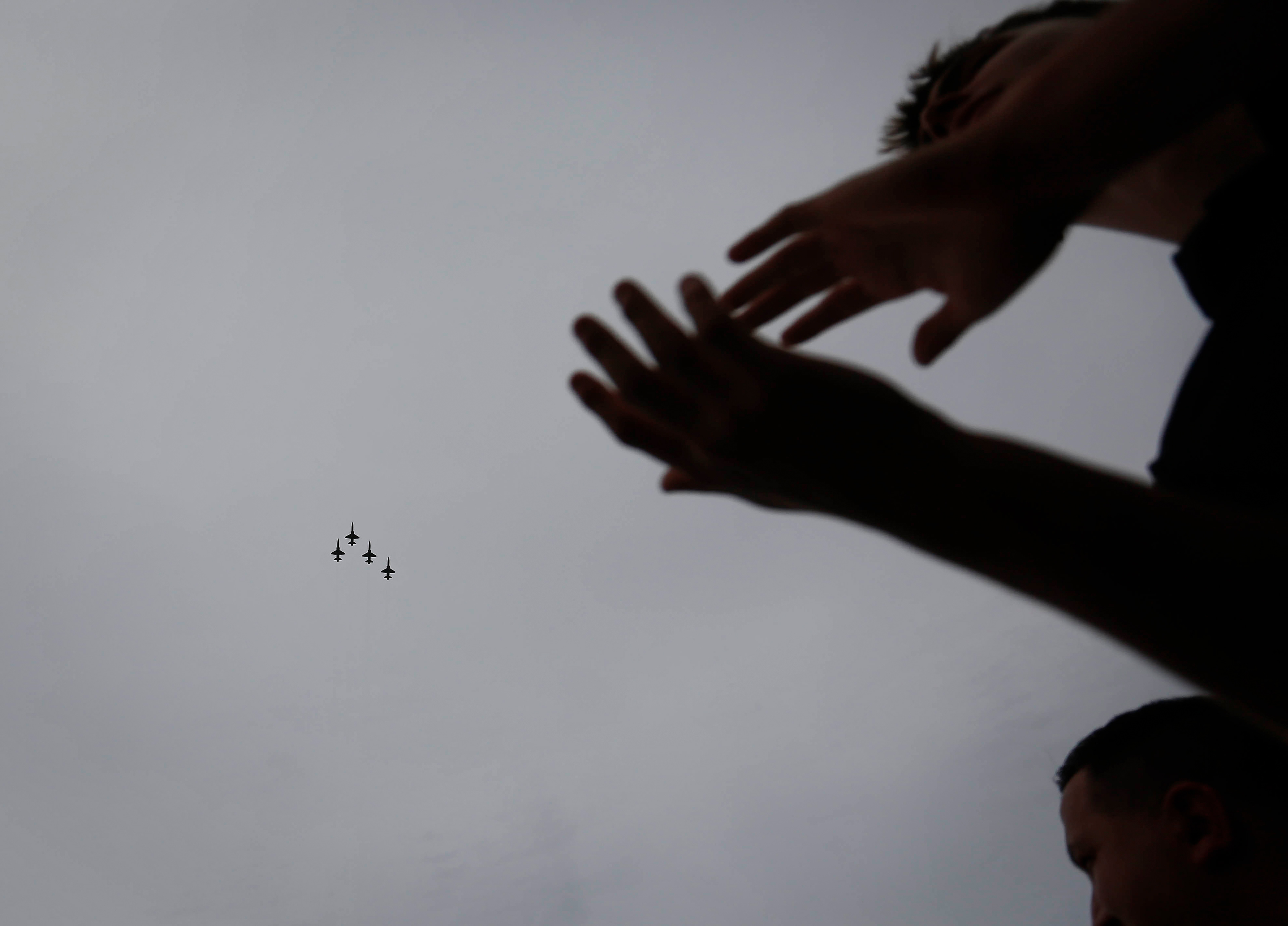 Iowa fans applaud as fighter jets fly over Kinnick Stadium in Iowa City, Iowa, on Saturday, Oct. 9, 2021, prior to kickoff between Iowa and Penn State. 