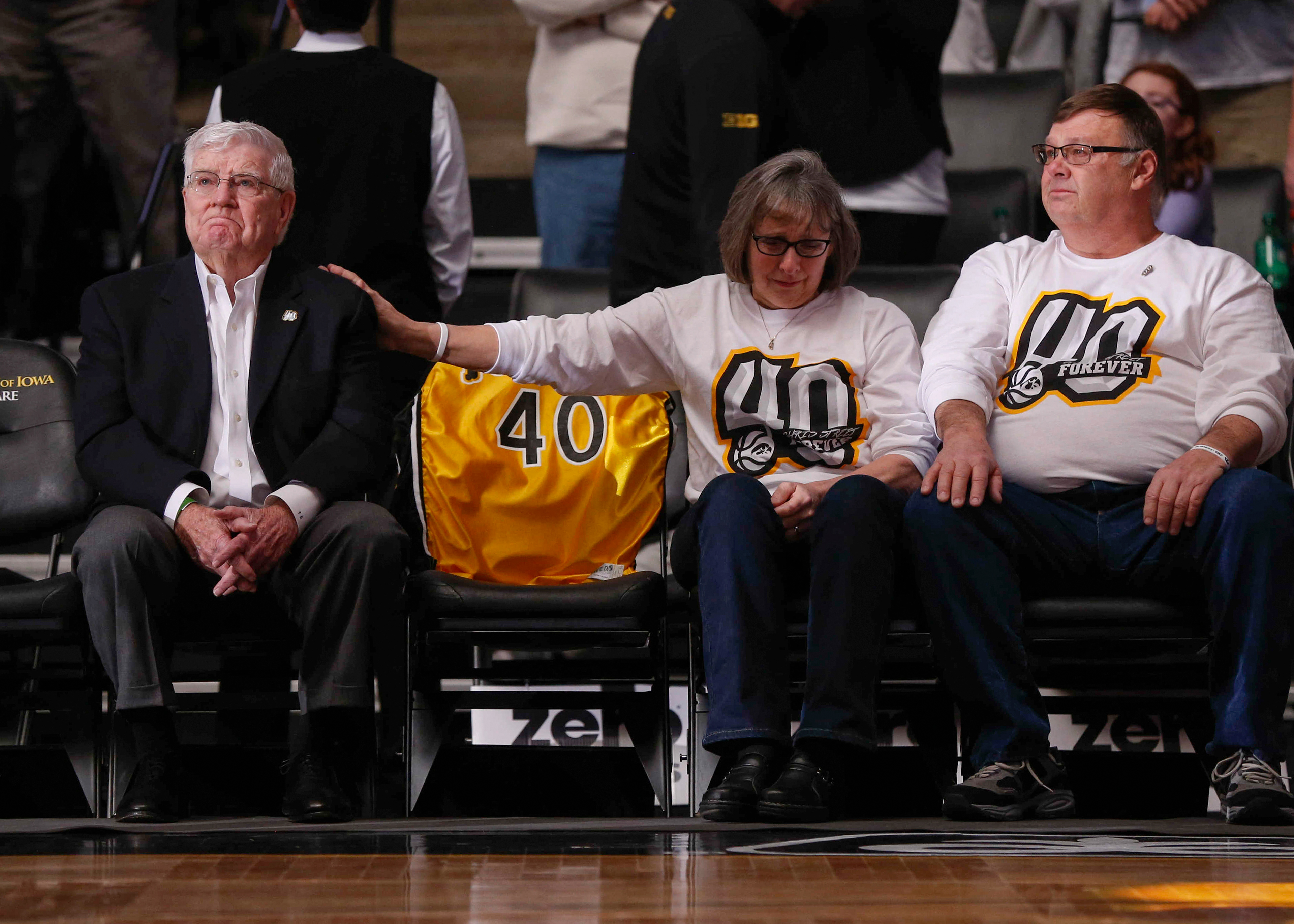 Former Iowa mens basketball head coach Tom Davis, left, is consoled by Patty Street, the mother of Chris Street, during a halftime ceremony against Purdue at Carver Hawkeye Arena in Iowa City on Saturday, January 20, 2018. This year marks the 25th anniversary of Street's death. 