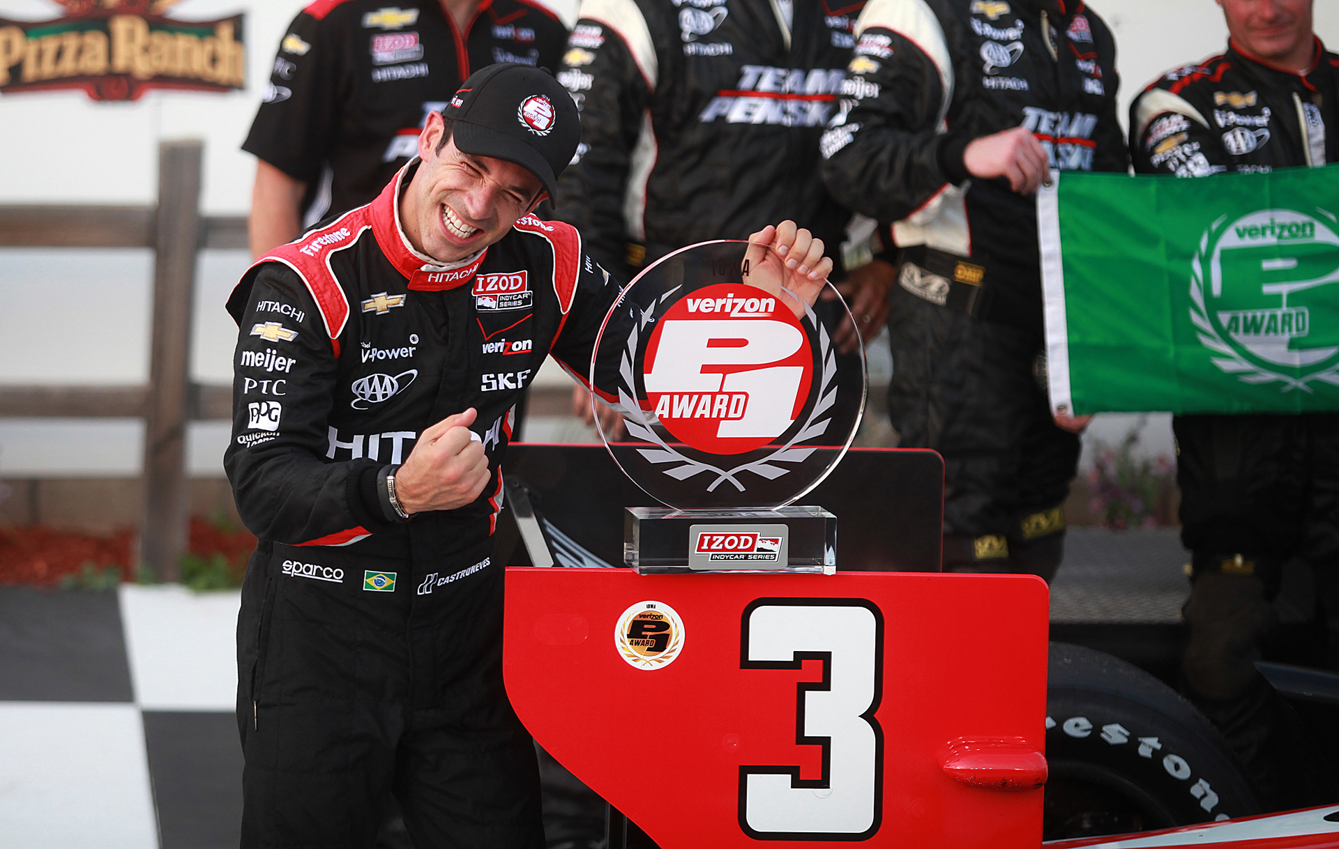 Indy driver Helio Castroneves celebrates after winning the pole on Saturday, June 22, 2013, at the Iowa Speedway in Newton, Iowa, for the Iowa Corn 250, which will be held on Sunday.