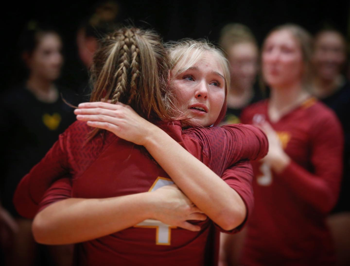 Members of the Ankeny volleyball team comfort each other after losing to Pleasant Valley in the semifinals of the 2021 Iowa high school girls state volleyball tournament in Cedar Rapids. 