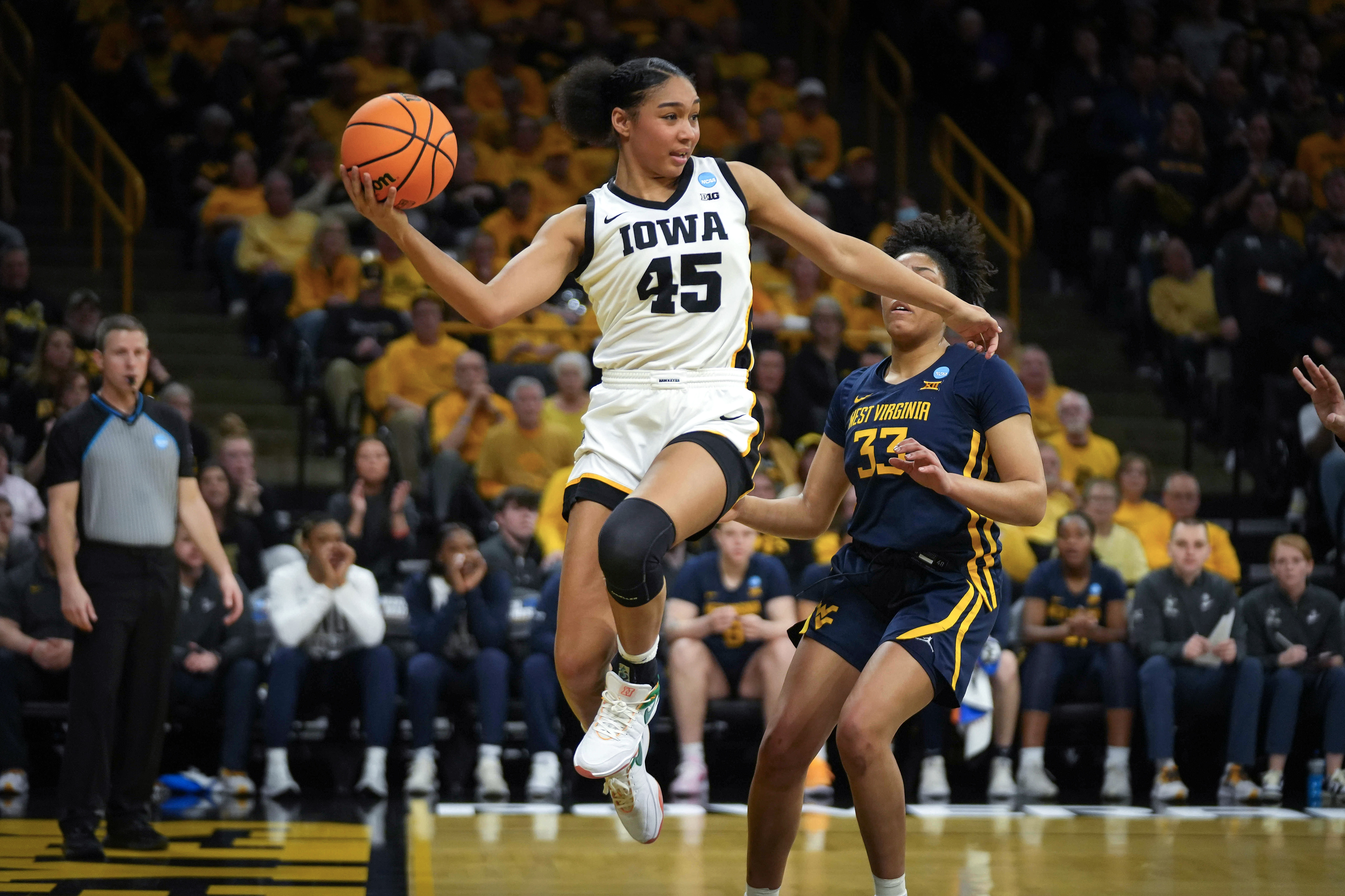 IOWA CITY, IOWA - MARCH 25: Hannah Stuelke #45 of the Iowa Hawkeyes saves the ball from going out of bounds against the West Virginia Mountaneers during the second round of the 2024 NCAA Women's Basketball Tournament held at Carver-Hawkeye Arena on March 25, 2024 in Iowa City, Iowa. (Photo by Bryon Houlgrave/NCAA Photos via Getty Images)