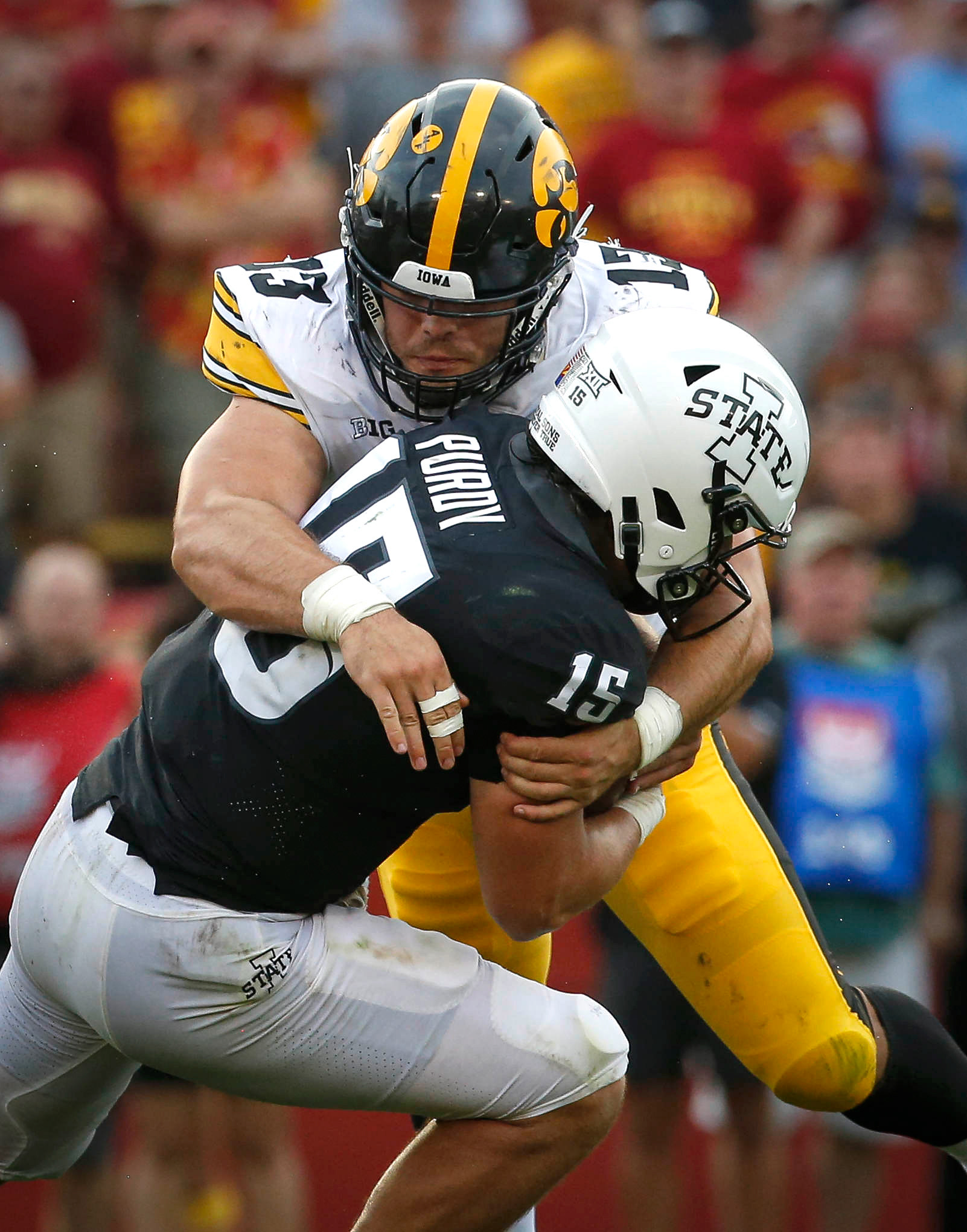 Iowa junior defensive end Joe Evans puts a hard hit on Iowa State senior quarterback Brock Purdy in the third quarter at Jack Trice Stadium in Ames on Saturday, Sept. 11, 2021.