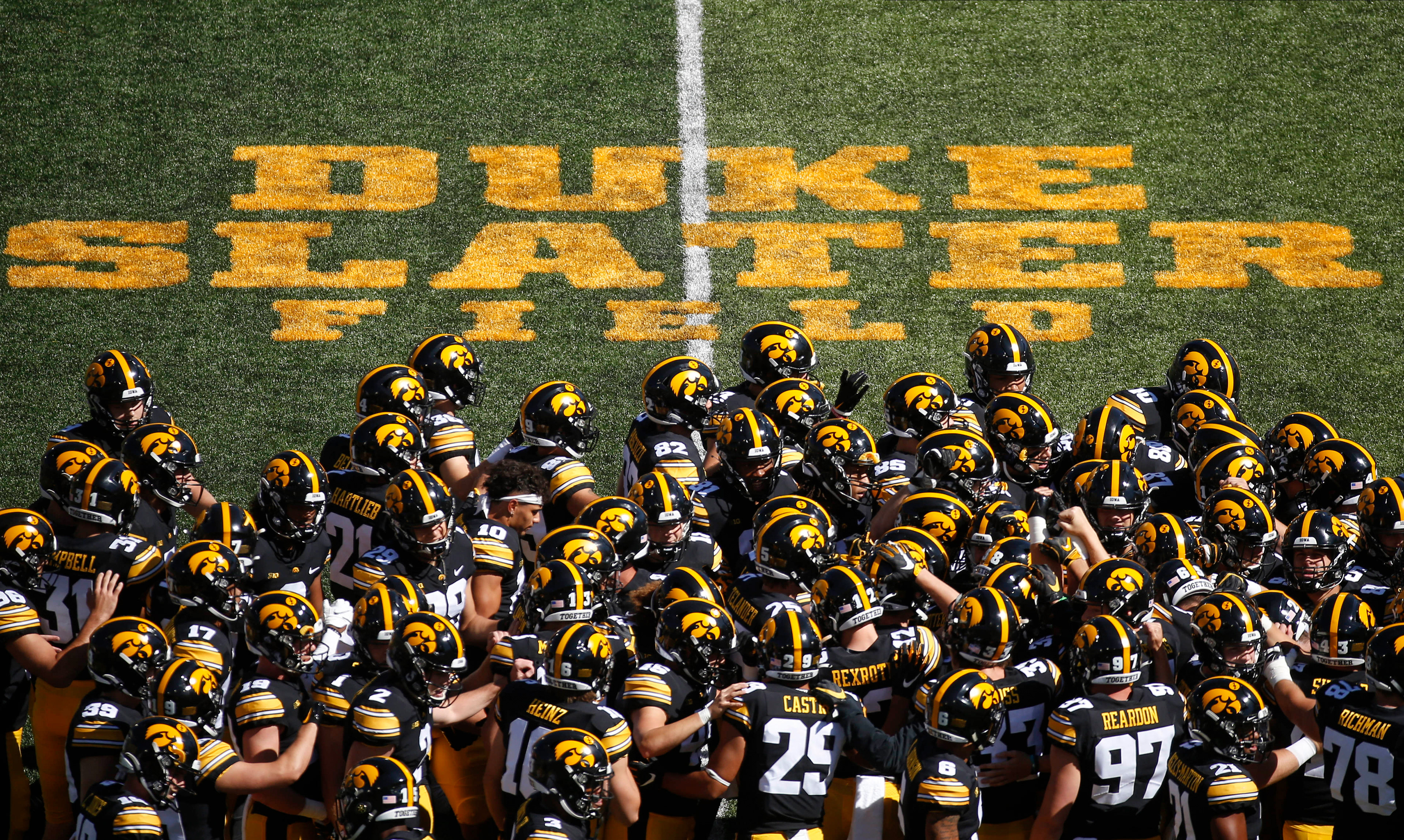 Members of the Iowa Hawkeyes football team huddle up on Duke Slater Field at Kinnick Stadium in Iowa City, Iowa, on Saturday, Sept. 25, 2021, prior to kickoff against Colorado State. 