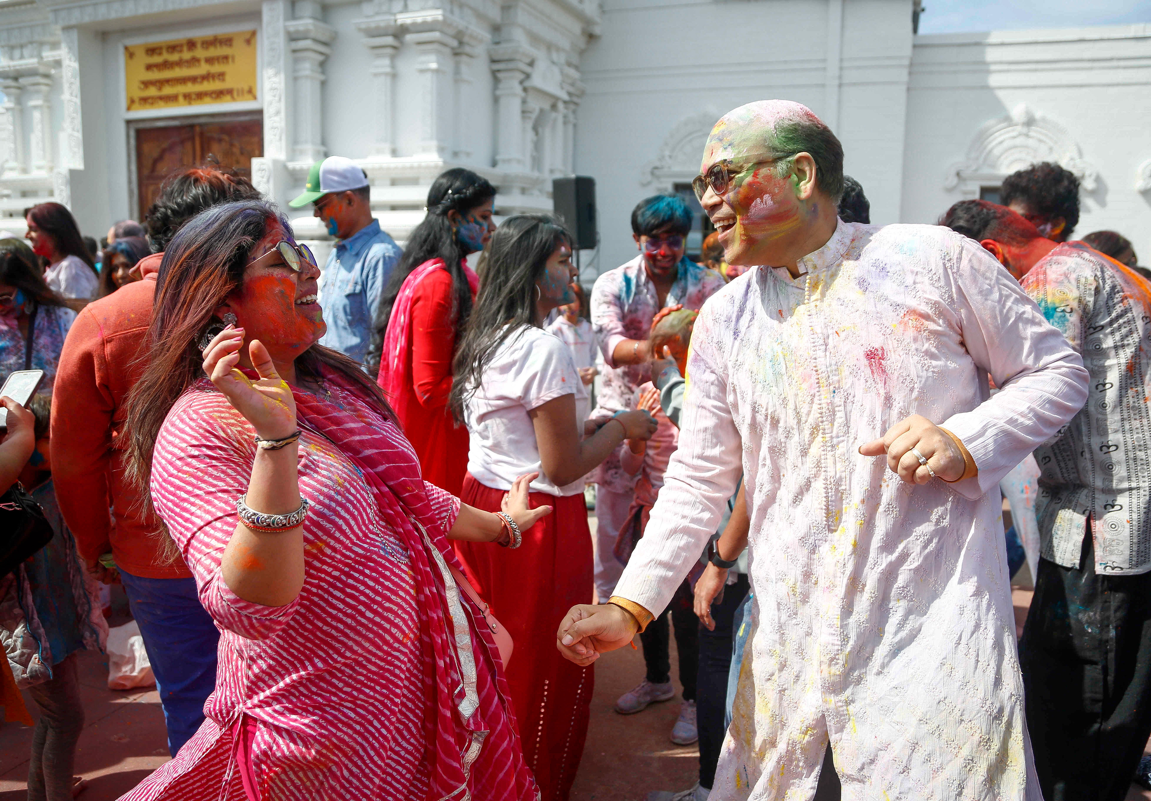 A couple dances during the Festival of Holi at the Hindu Temple in Madrid, Iowa.