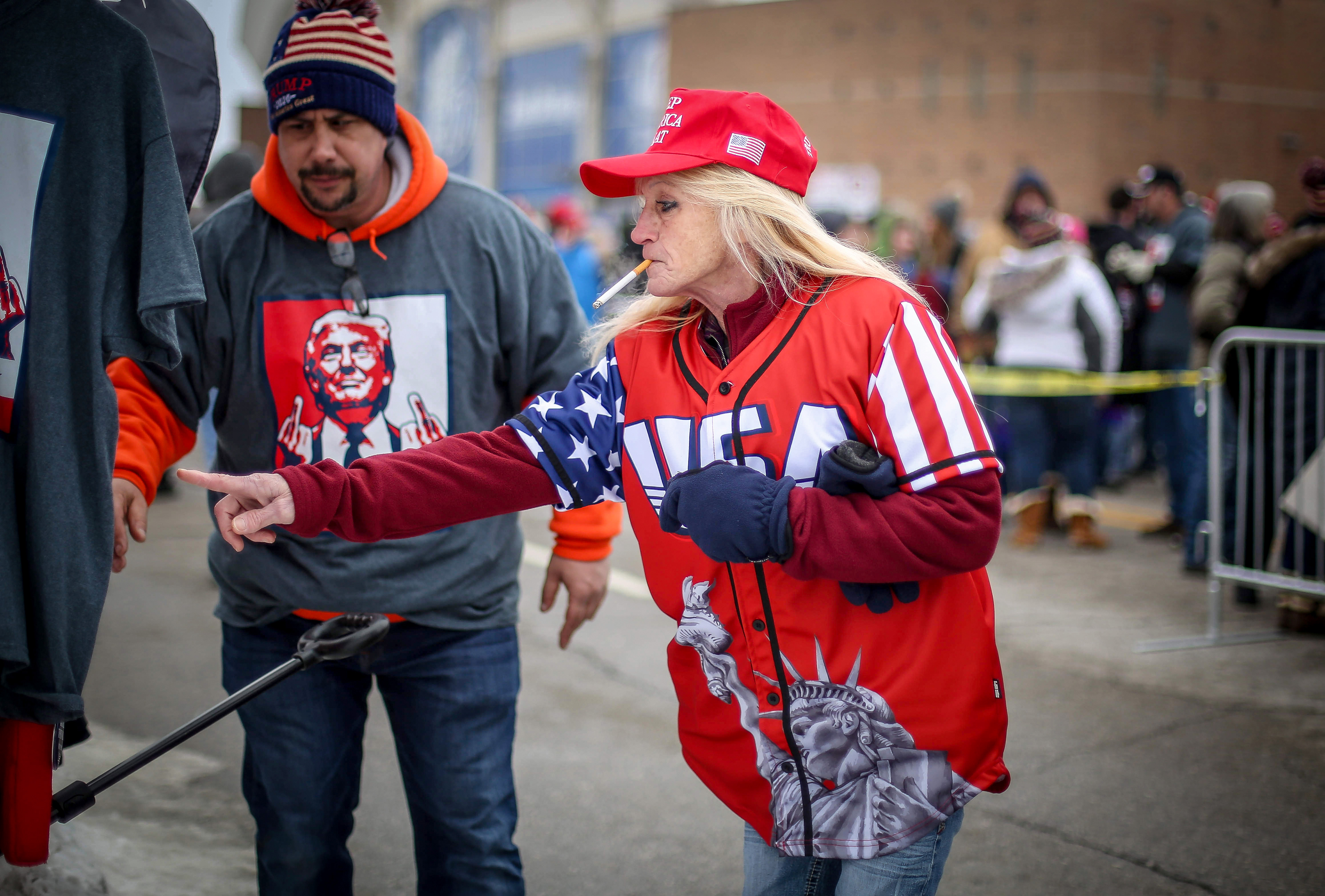 Lawana Frohwein of Gilman, Iowa, looks over a selection of campaign buttons at a merchandise stand outside the Knapp Center on Thursday, Jan. 30, 2020, at Drake University in Des Moines. Frohwein was on of thousands who showed up to wait outside for a visit from President Donald Trump.