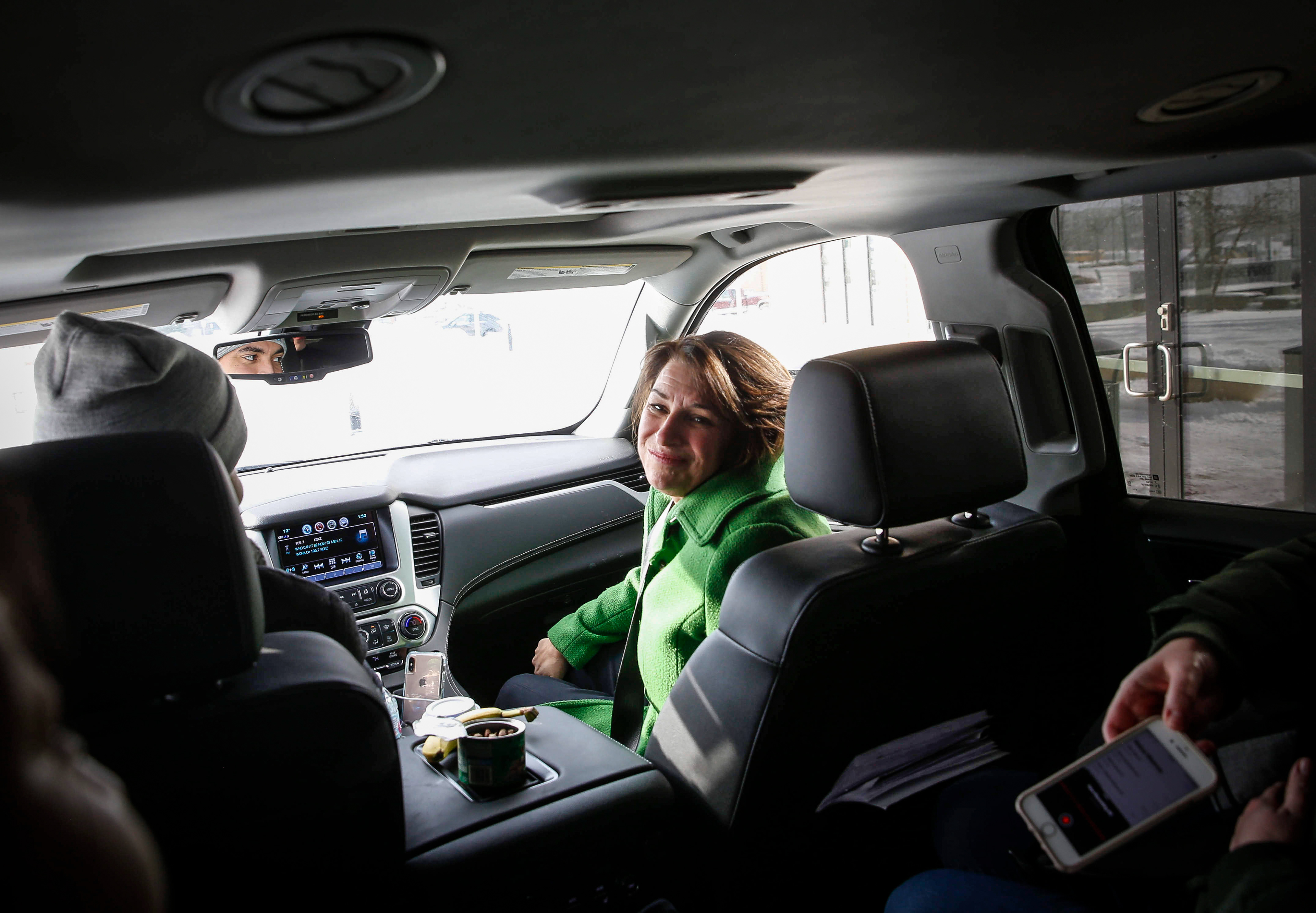 U.S. Sen. Amy Klobuchar hears from her press advisor on the details of their next campaign stop after she spoke to supporters at the Marriott Hotel in Coralville.