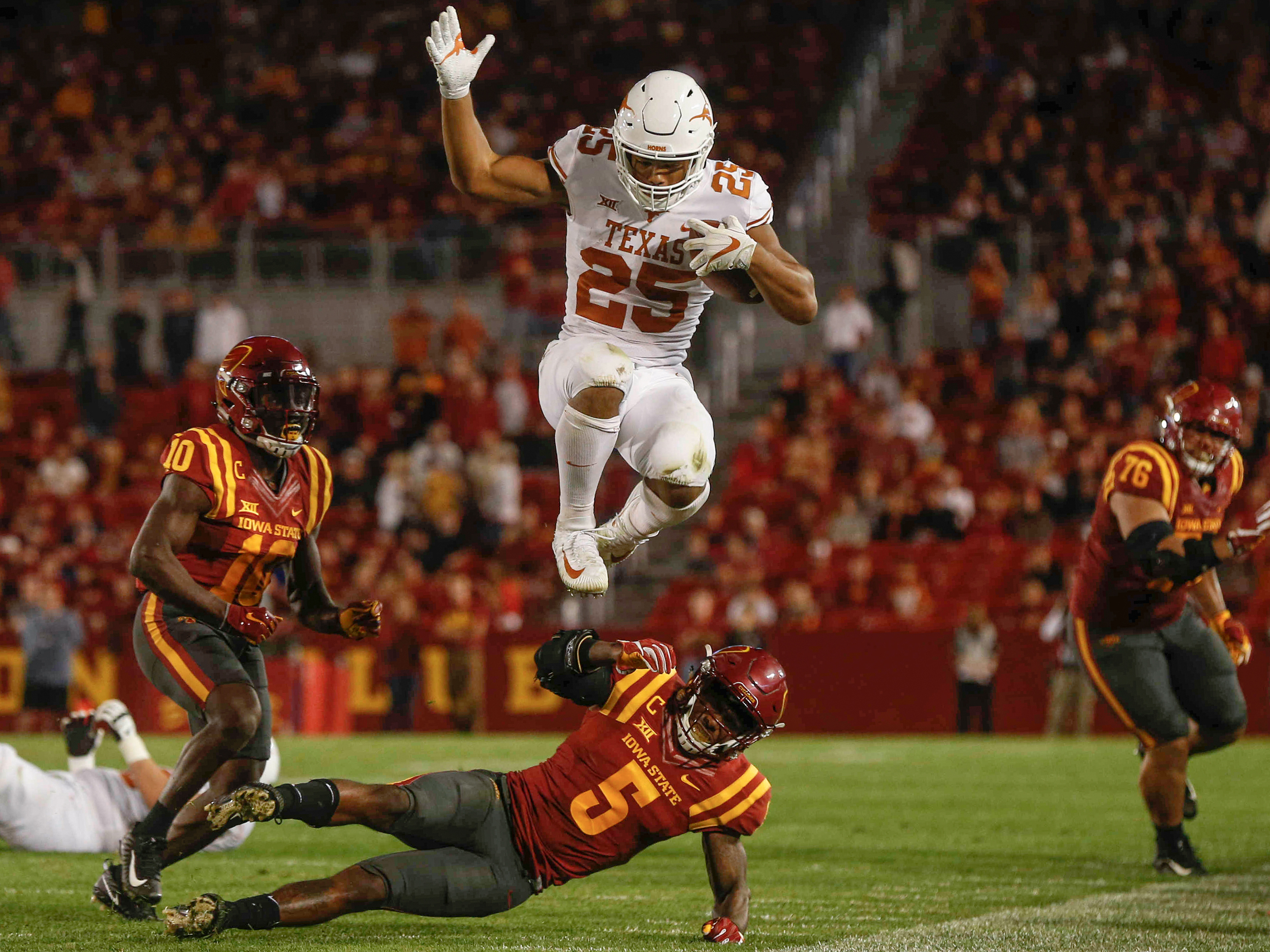 Texas running back Chris Warren III hurdles Iowa State safety Kamari Cotton-Moya on Thursday, Sept. 28, 2017, at Jack Trice Stadium in Ames.