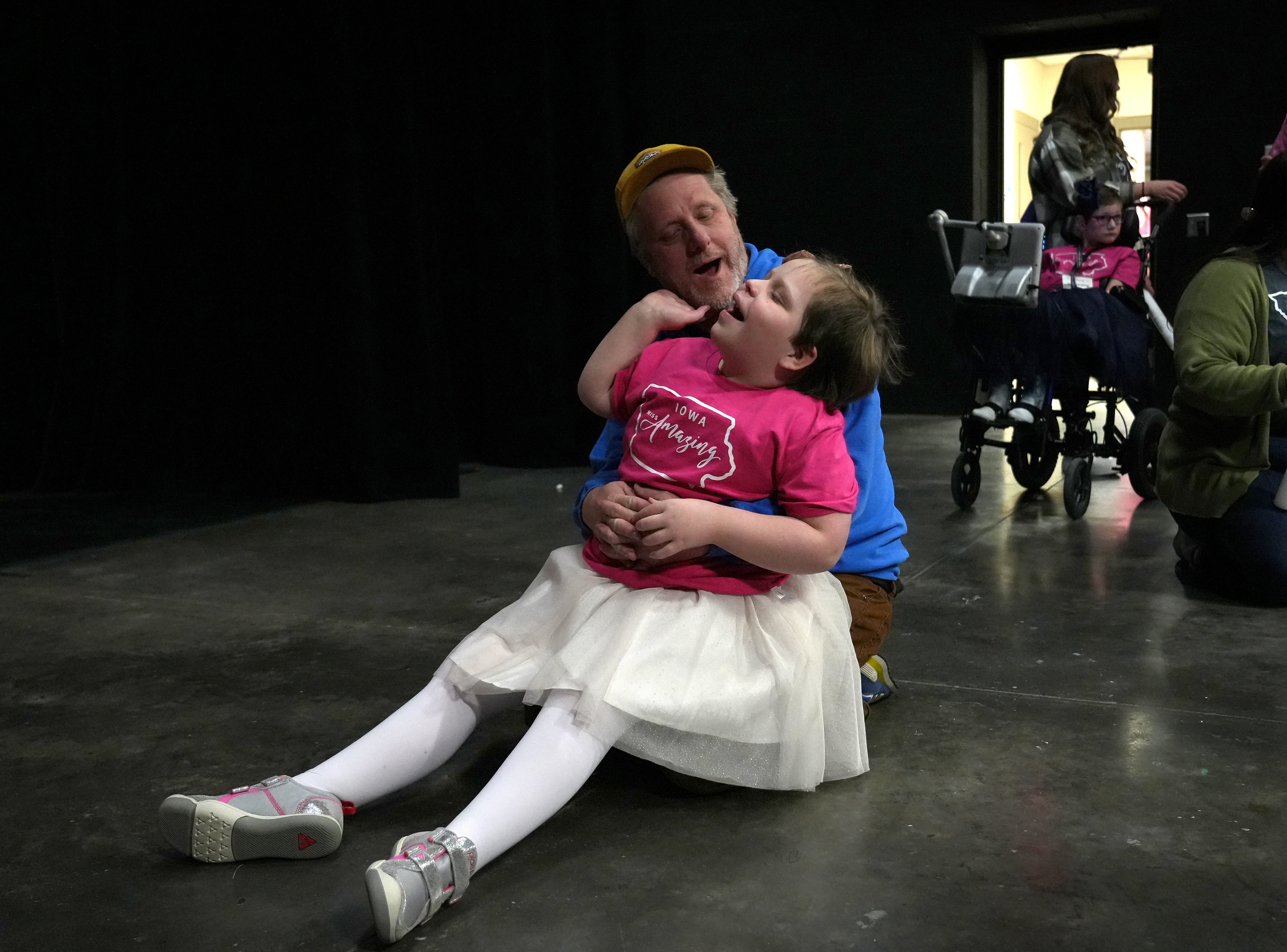 Iowa Miss Amazing rising star participant Ellie Kimble shares a quiet moment with her dad backstage prior to her passion presentation during the 11th Annual Iowa Miss Amazing pageant on Saturday, Feb. 4, 2023, in Urbandale, Iowa.