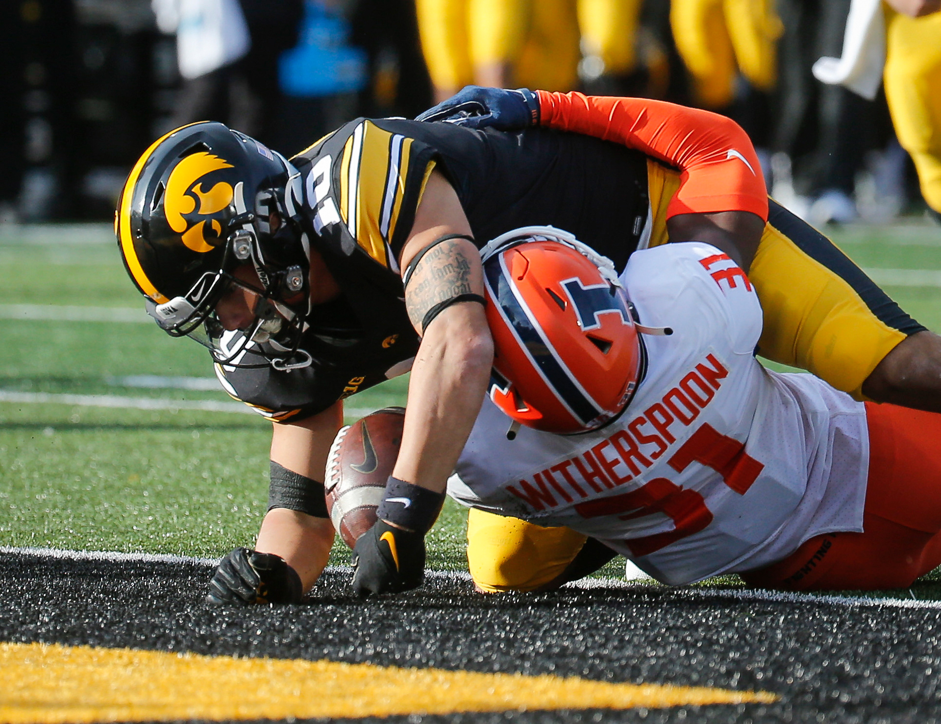 Iowa freshman wide receiver Arland Bruce, IV, scores a touchdown over the defensive effort of Illinois cornerback Devin Witherspoon in the second quarter on Saturday, Nov. 20, 2021, at Kinnick Stadium in Iowa City, Iowa.